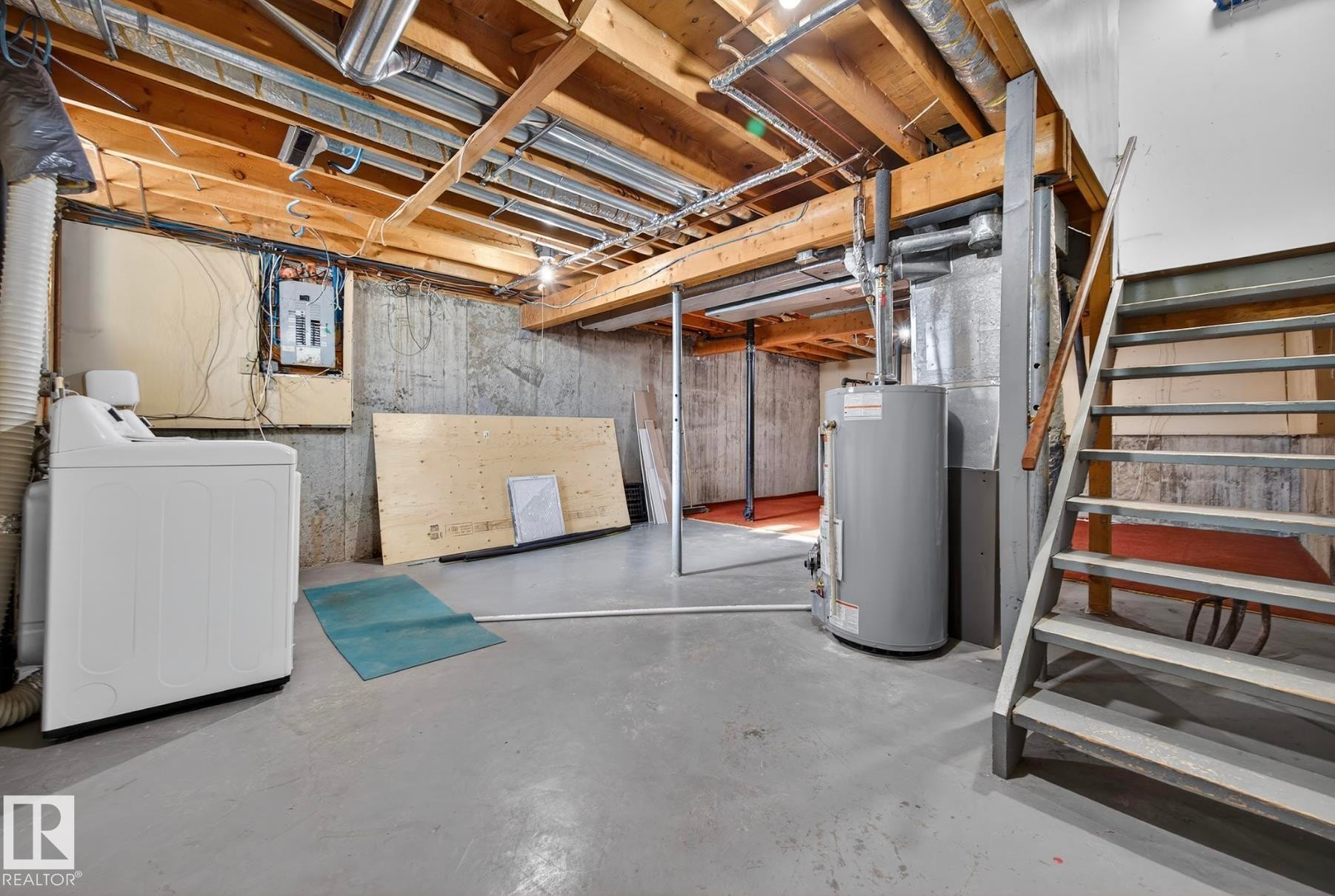 Unfinished basement with washer / dryer, gas water heater, and electric panel - 9969 171 Ave, Edmonton, AB - Indoor Photo Showing Basement