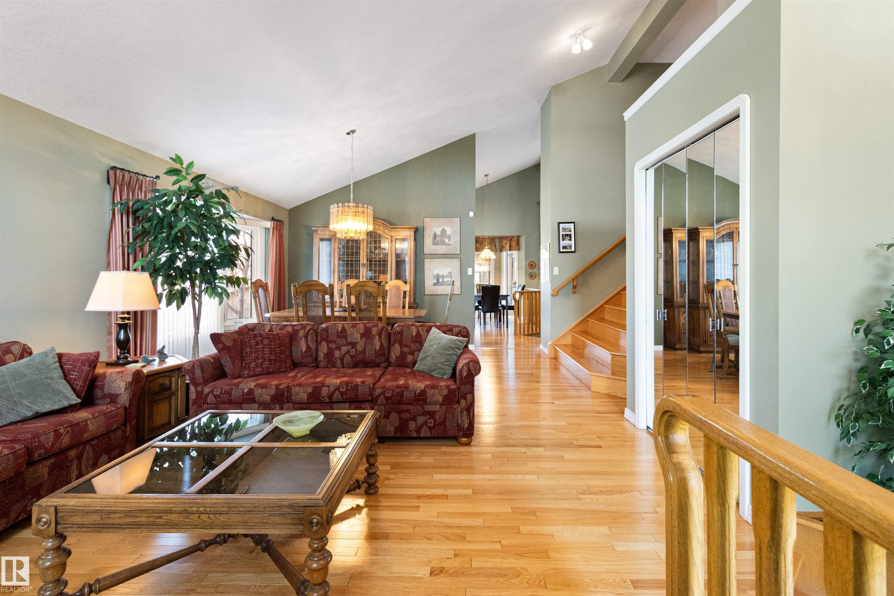 Living room featuring light wood finished floors, a chandelier, and lofted ceiling - 519 Buchanan Road, Edmonton, AB - Indoor Photo Showing Living Room