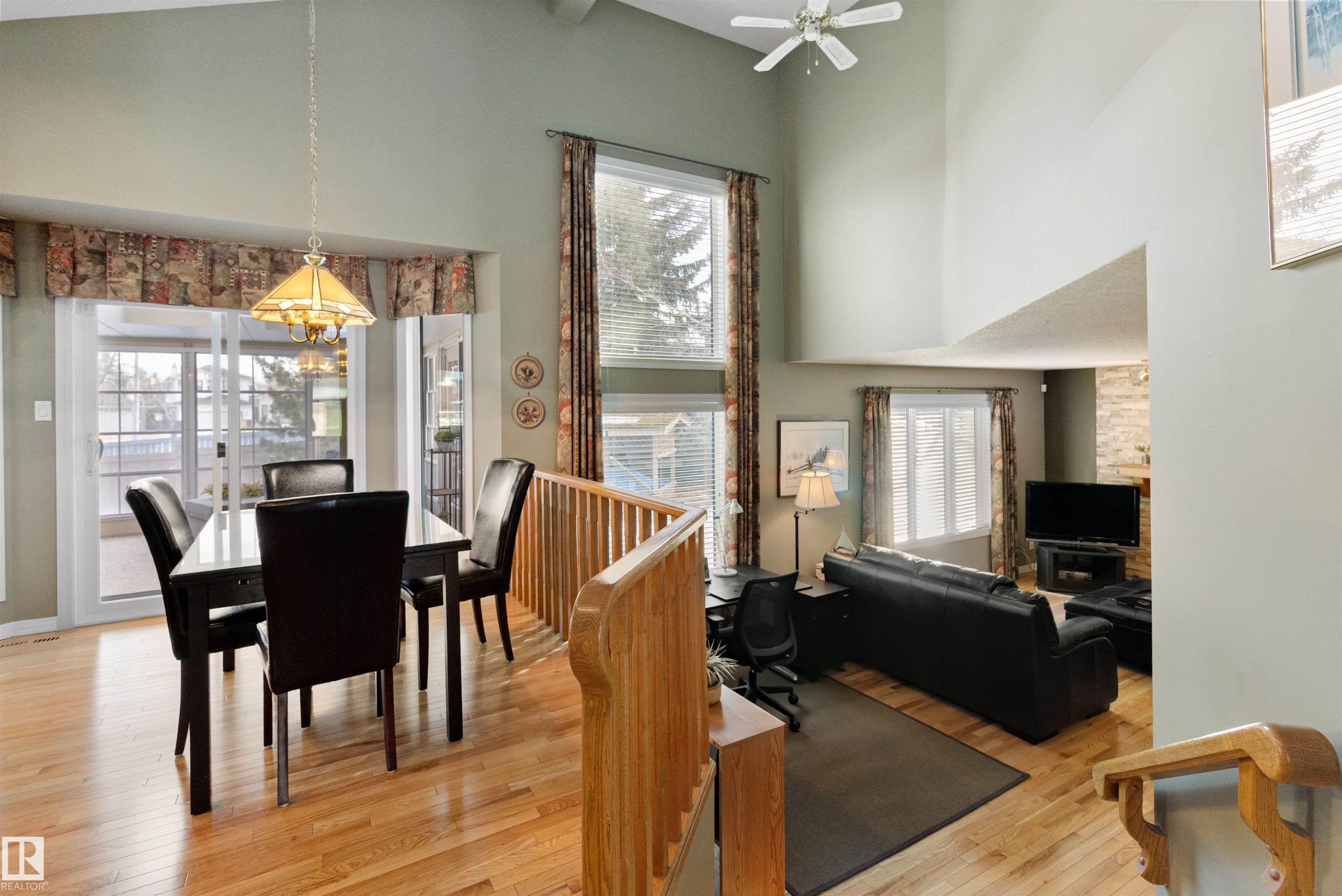 Dining space featuring a high ceiling, light wood-style flooring, suspended lighting, plenty of natural light, and ceiling fan - 519 Buchanan Road, Edmonton, AB - Indoor Photo Showing Dining Room