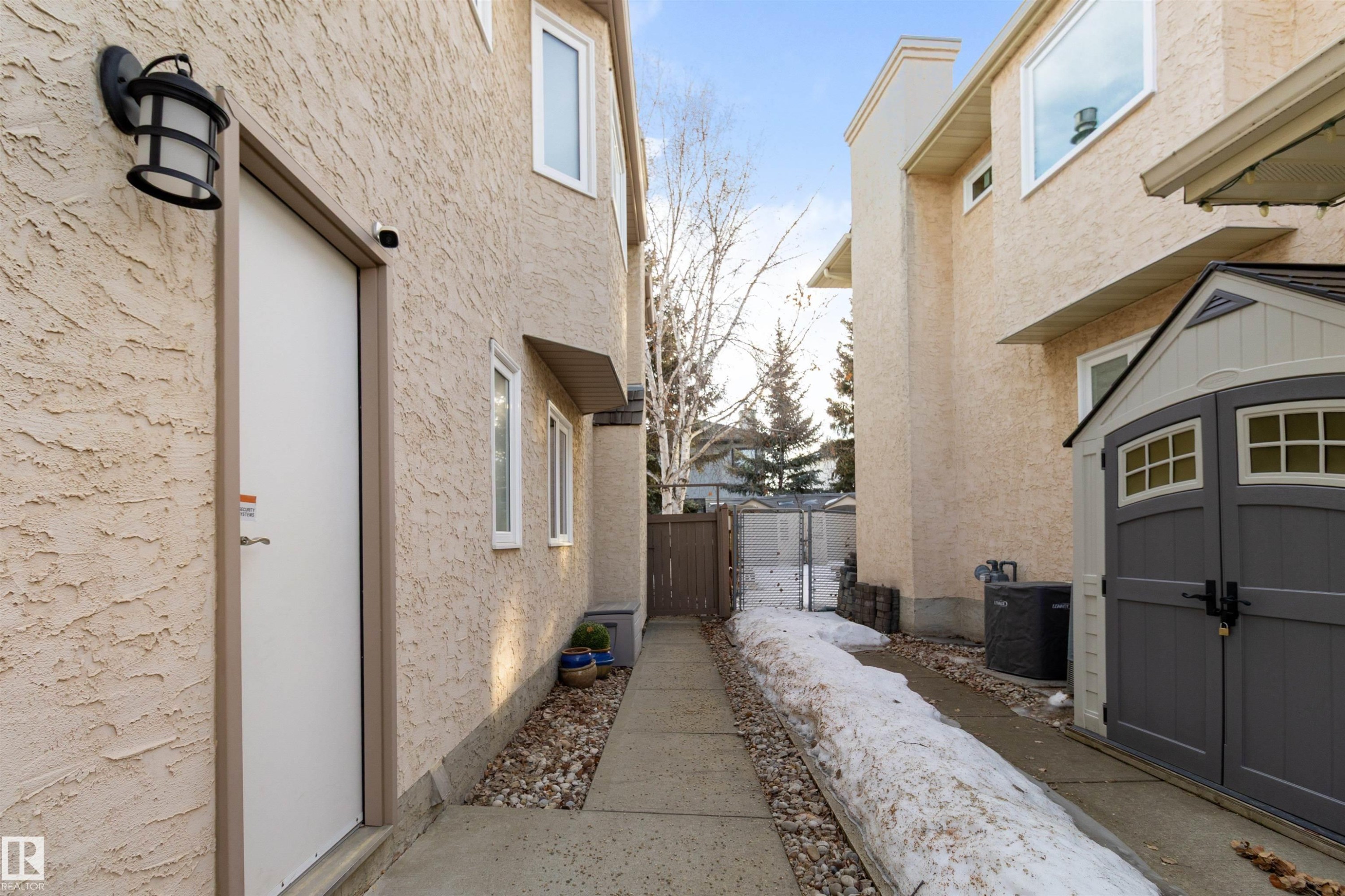 View of property exterior featuring a storage unit and stucco siding - 519 Buchanan Road, Edmonton, AB - Outdoor With Exterior