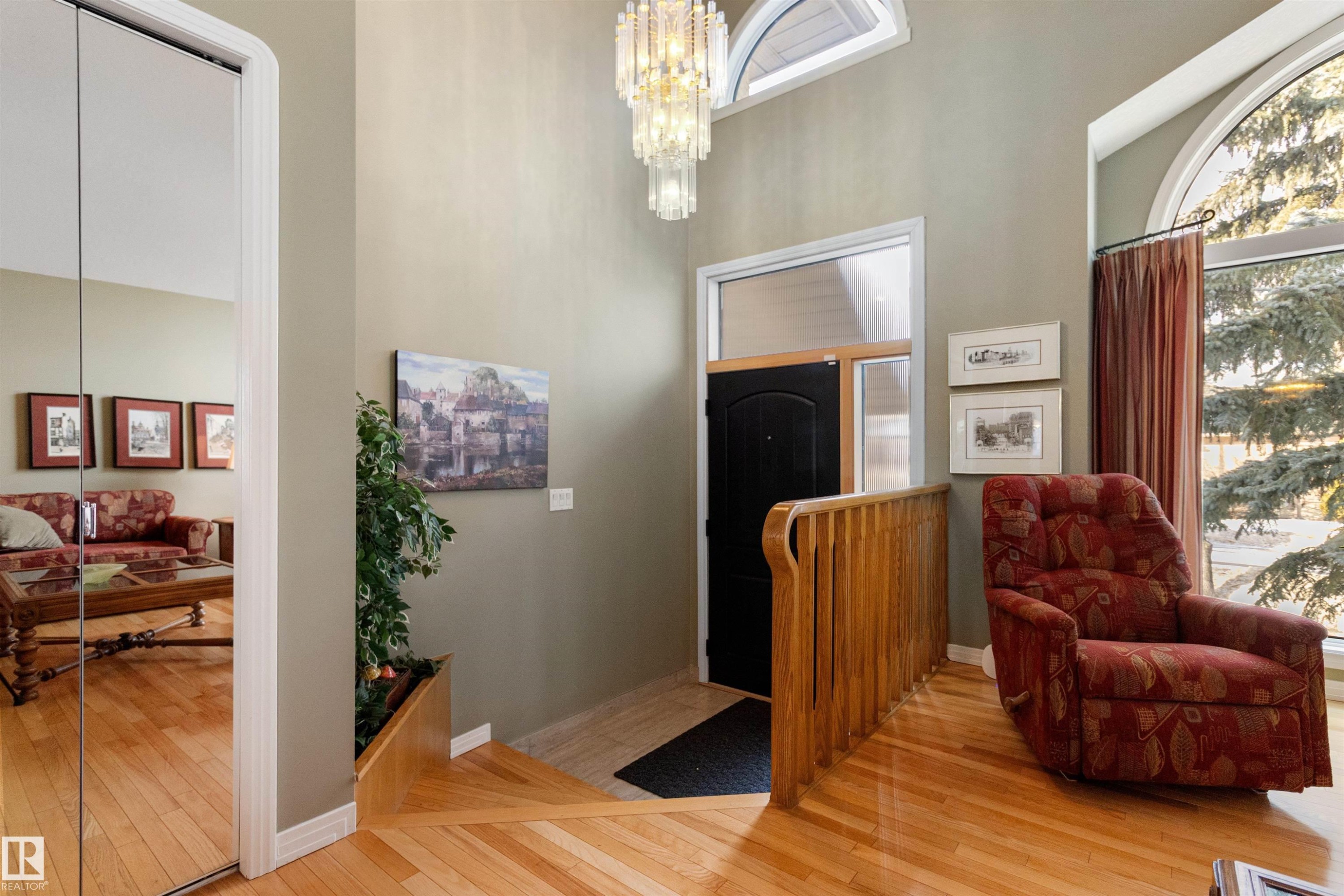 Foyer entrance featuring light wood-style flooring, a chandelier, and a high ceiling - 519 Buchanan Road, Edmonton, AB - Indoor Photo Showing Other Room