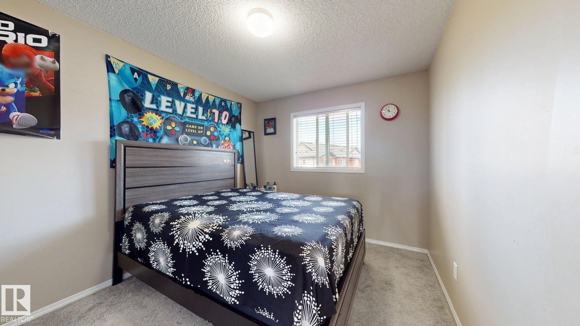 Bedroom with a textured ceiling and light colored carpet - 1150 37B Avenue, Edmonton, AB - Indoor Photo Showing Bedroom
