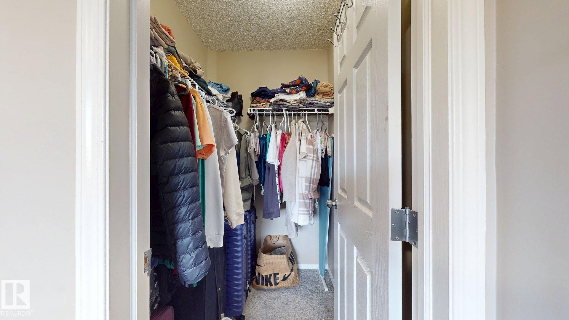 Walk in closet featuring light colored carpet - 1150 37B Avenue, Edmonton, AB - Indoor With Storage