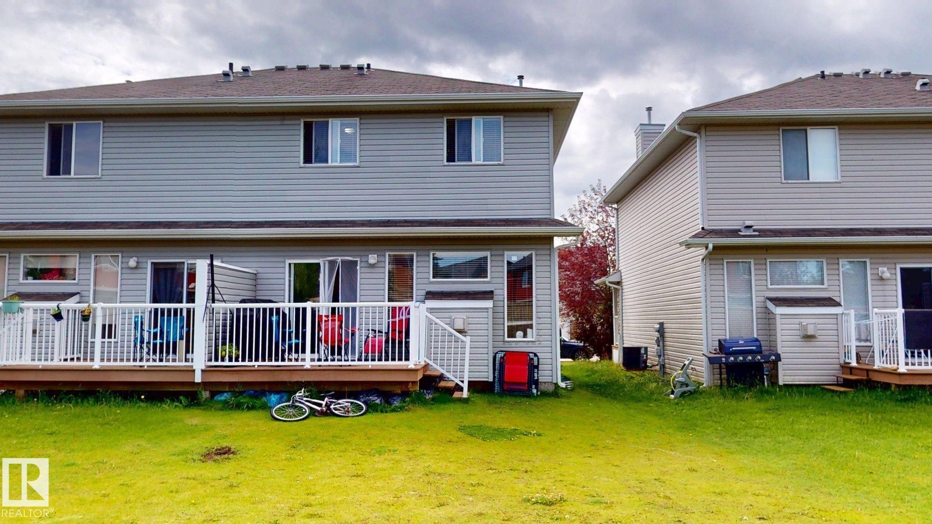 Rear view of house with a deck and a lawn - 1150 37B Avenue, Edmonton, AB - Outdoor With Deck Patio Veranda With Exterior