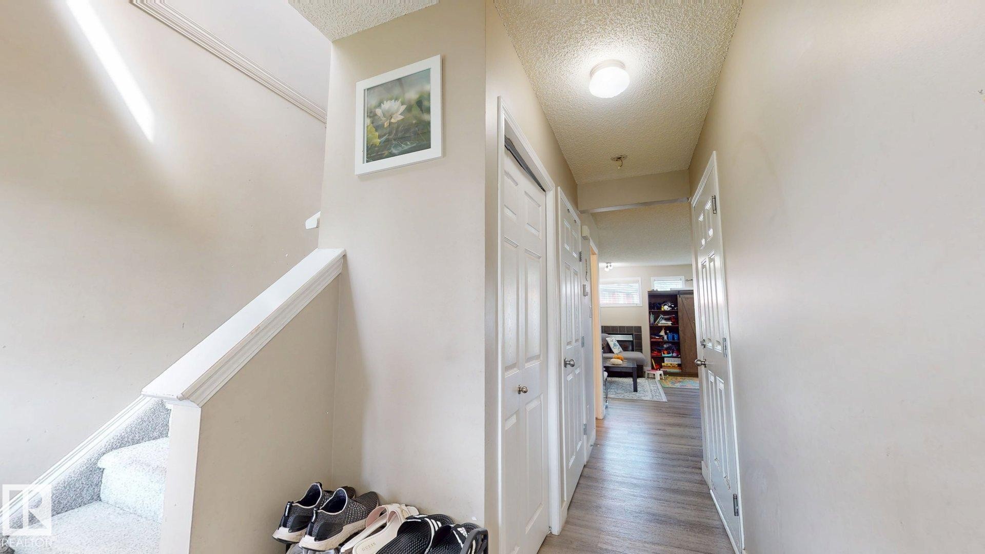 Hall with a textured ceiling and wood finished floors - 1150 37B Avenue, Edmonton, AB - Indoor Photo Showing Other Room
