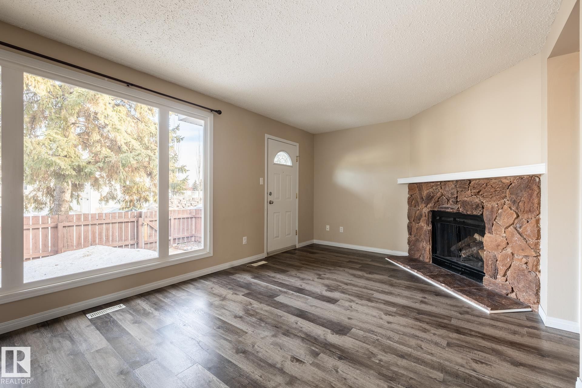 Edmonton, AB - Indoor Photo Showing Living Room With Fireplace