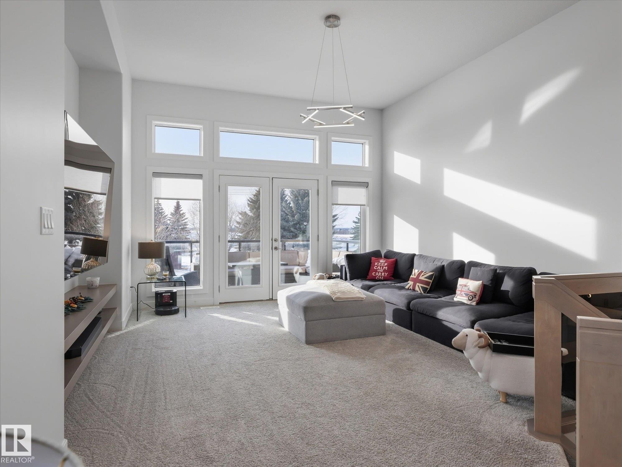 Bright and airy living room with south west facing deck. - 1562 Howes Place, Edmonton, AB - Indoor Photo Showing Living Room