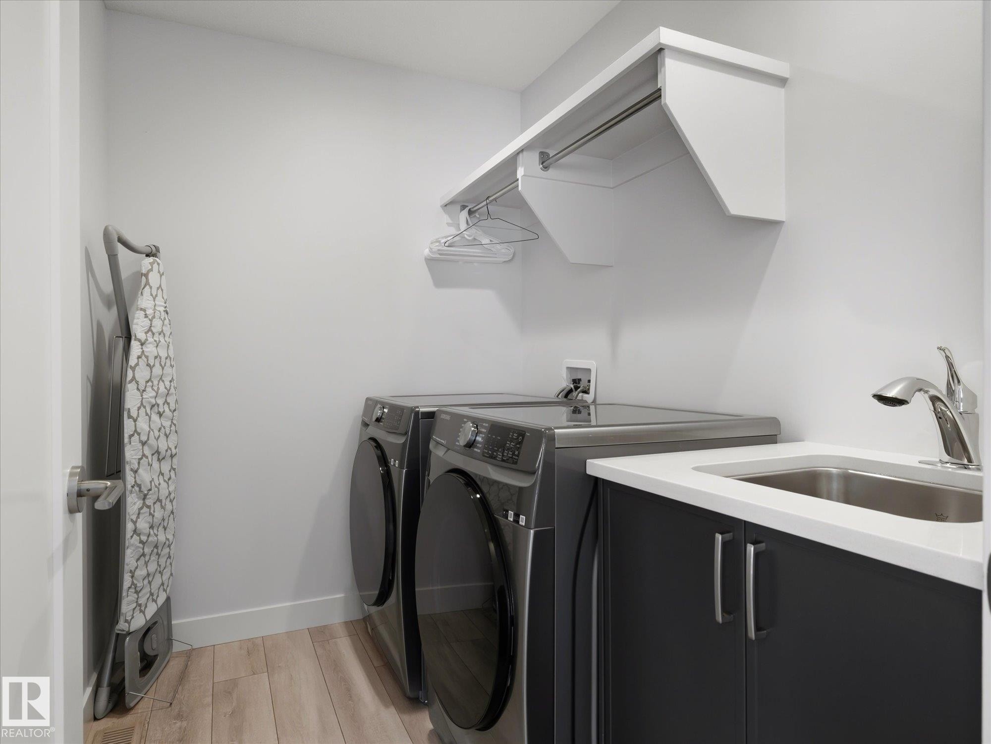 2nd floor laundry room with sink and storage. - 1562 Howes Place, Edmonton, AB - Indoor Photo Showing Laundry Room