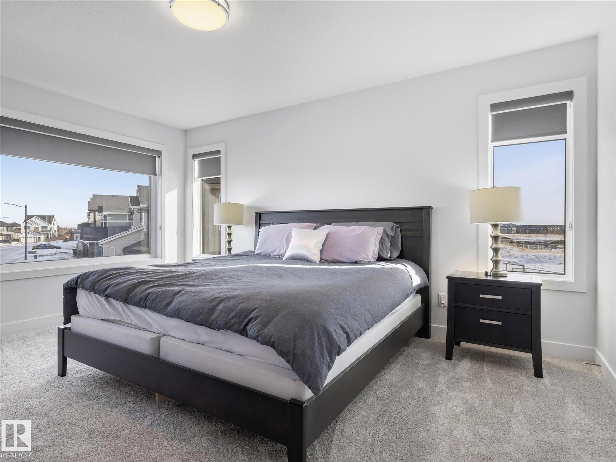 Both additional bedrooms have large closets and expansive windows plus a shared ensuite bath. - 1562 Howes Place, Edmonton, AB - Indoor Photo Showing Bedroom