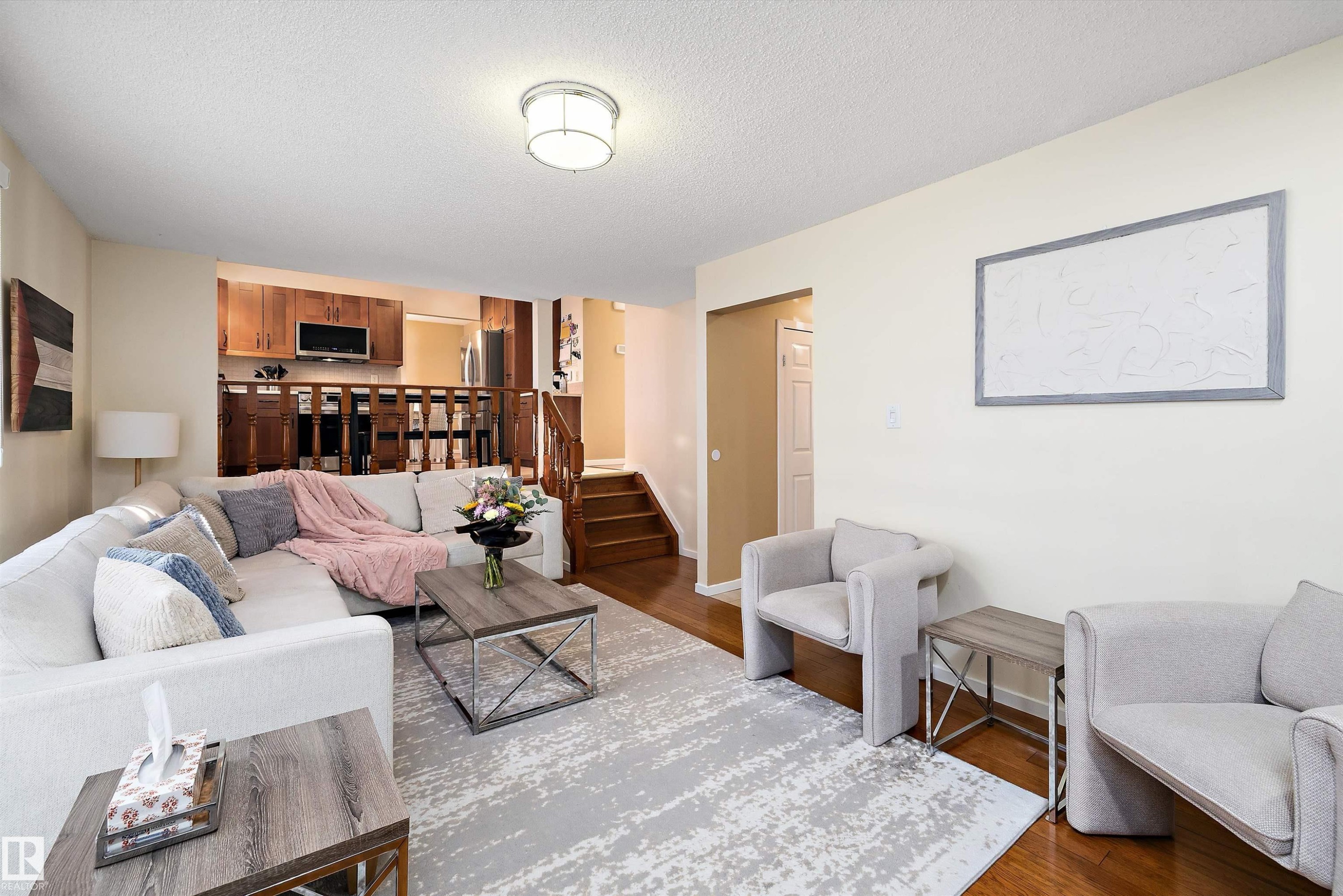 Living room featuring wood finished floors and a textured ceiling - 9804 156 Avenue, Edmonton, AB - Indoor Photo Showing Living Room
