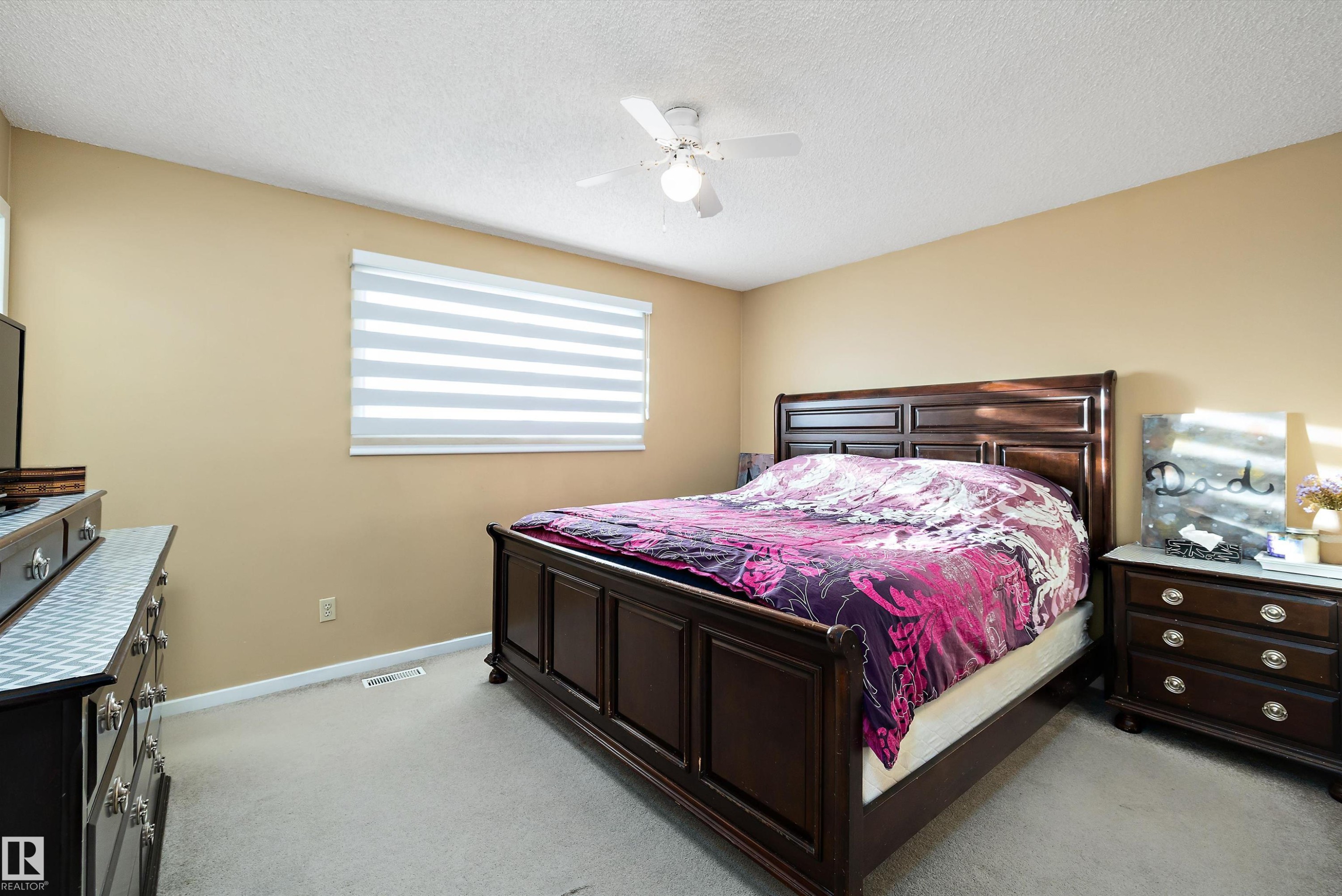 Bedroom with light colored carpet, a ceiling fan, and a textured ceiling - 9804 156 Avenue, Edmonton, AB - Indoor Photo Showing Bedroom