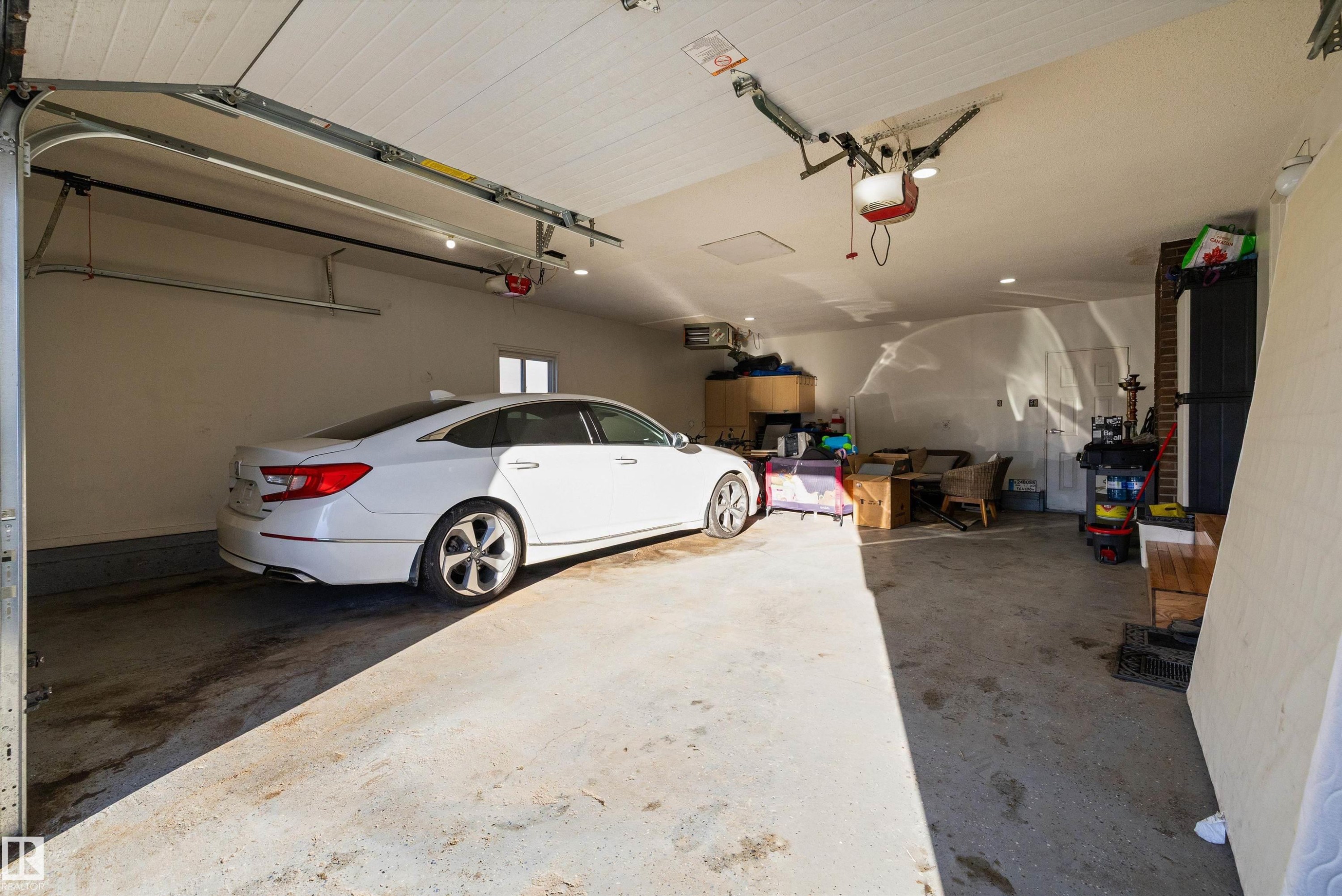 Garage featuring a heating unit and a garage door opener - 9804 156 Avenue, Edmonton, AB - Indoor Photo Showing Garage