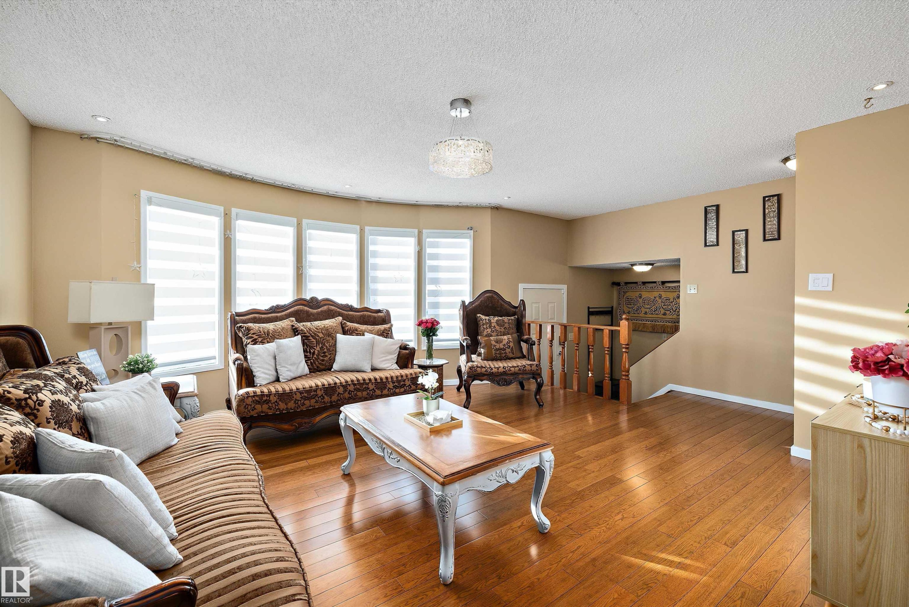 Living area with light wood-type flooring and a textured ceiling - 9804 156 Avenue, Edmonton, AB - Indoor Photo Showing Living Room