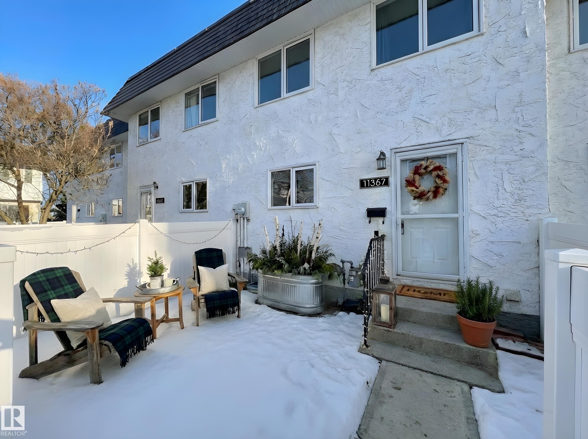 Rear view of property featuring stucco siding and a patio area - 11357 22 Avenue, Edmonton, AB - Outdoor With Exterior