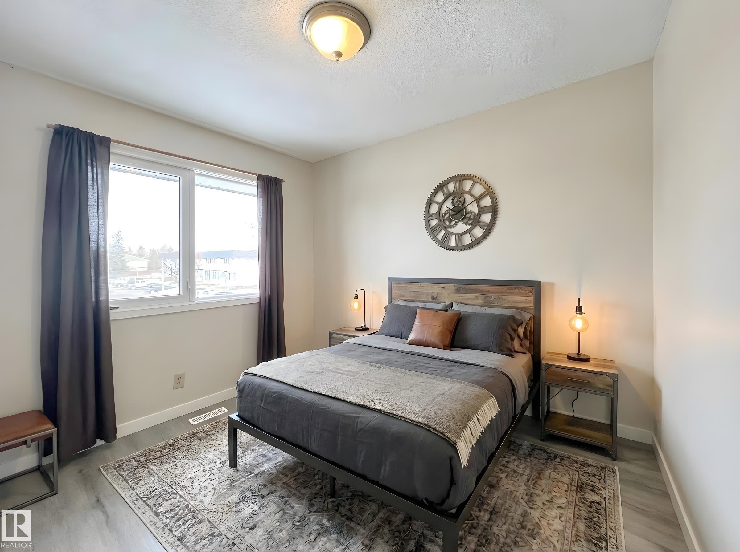 Bedroom featuring baseboards and light wood-type flooring - 11357 22 Avenue, Edmonton, AB - Indoor Photo Showing Bedroom