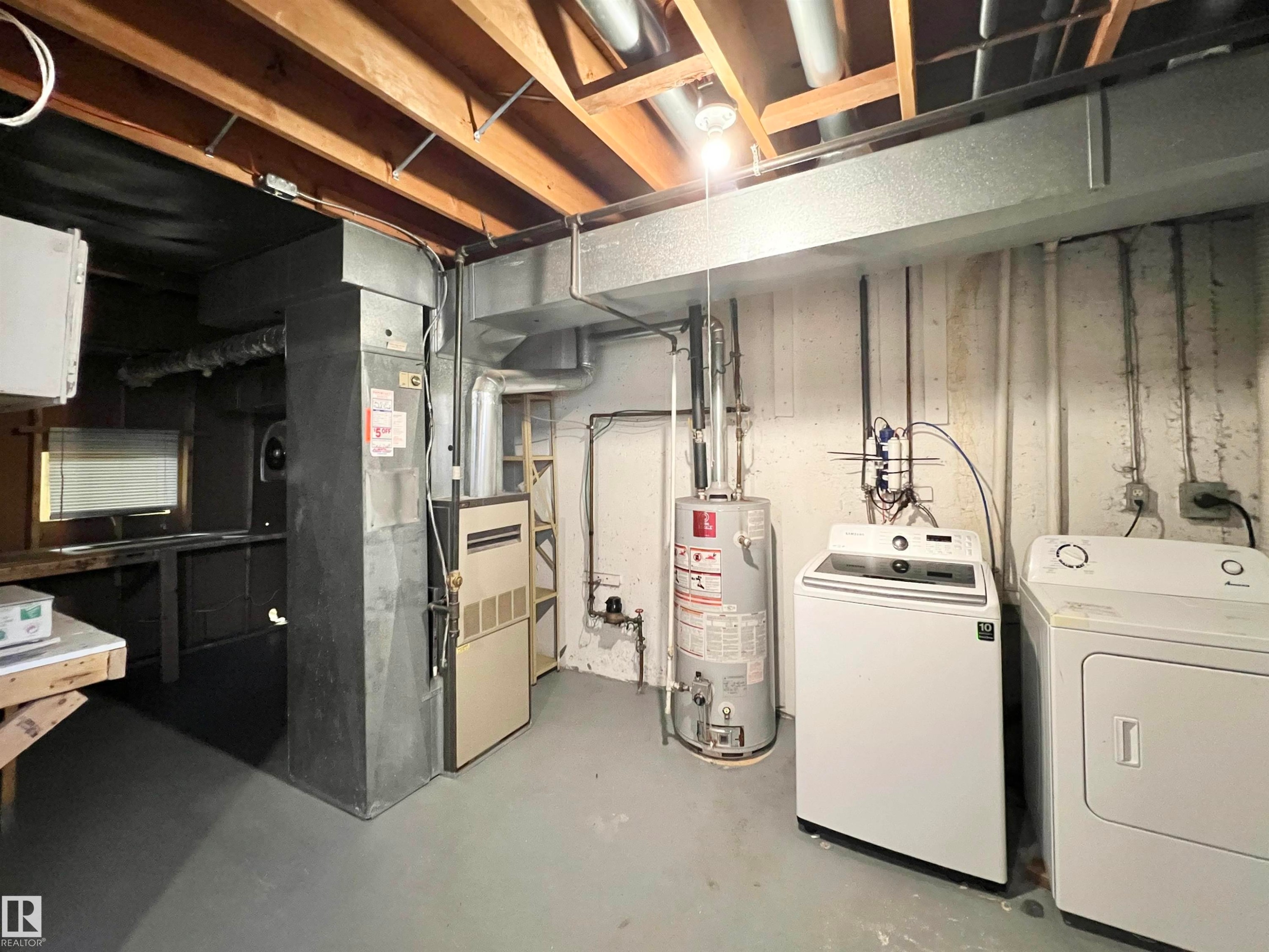 Unfinished basement featuring gas water heater and washer and clothes dryer - 11357 22 Avenue, Edmonton, AB - Indoor Photo Showing Laundry Room