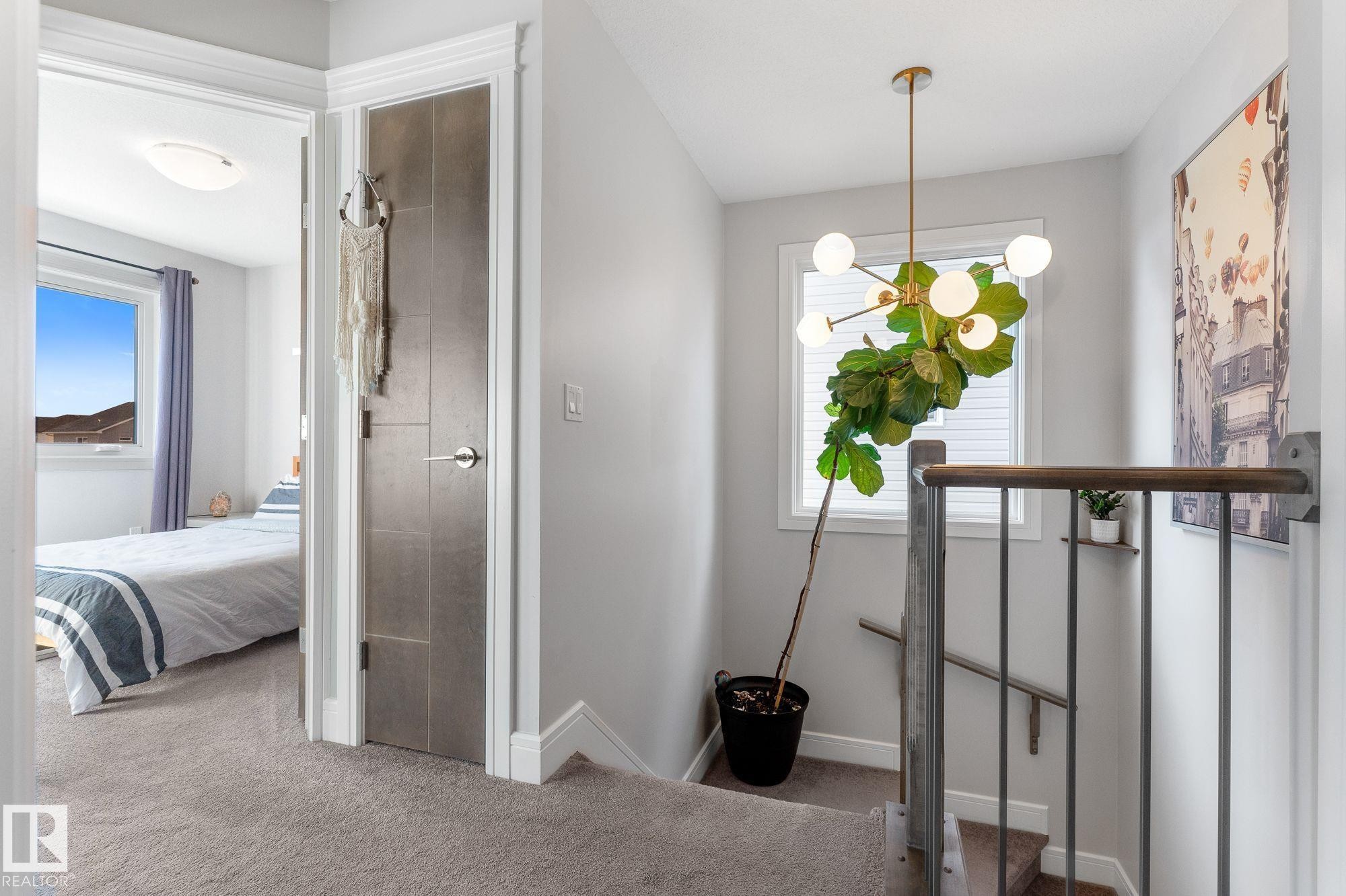 Hallway featuring carpet flooring and healthy amount of natural light - 89 Hewitt Circle, Spruce Grove, AB - Indoor