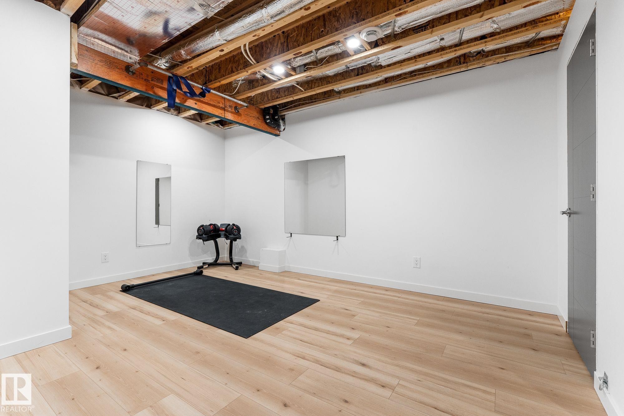 Partially Finished basement with baseboards and wood finished floors - 89 Hewitt Circle, Spruce Grove, AB - Indoor Photo Showing Basement