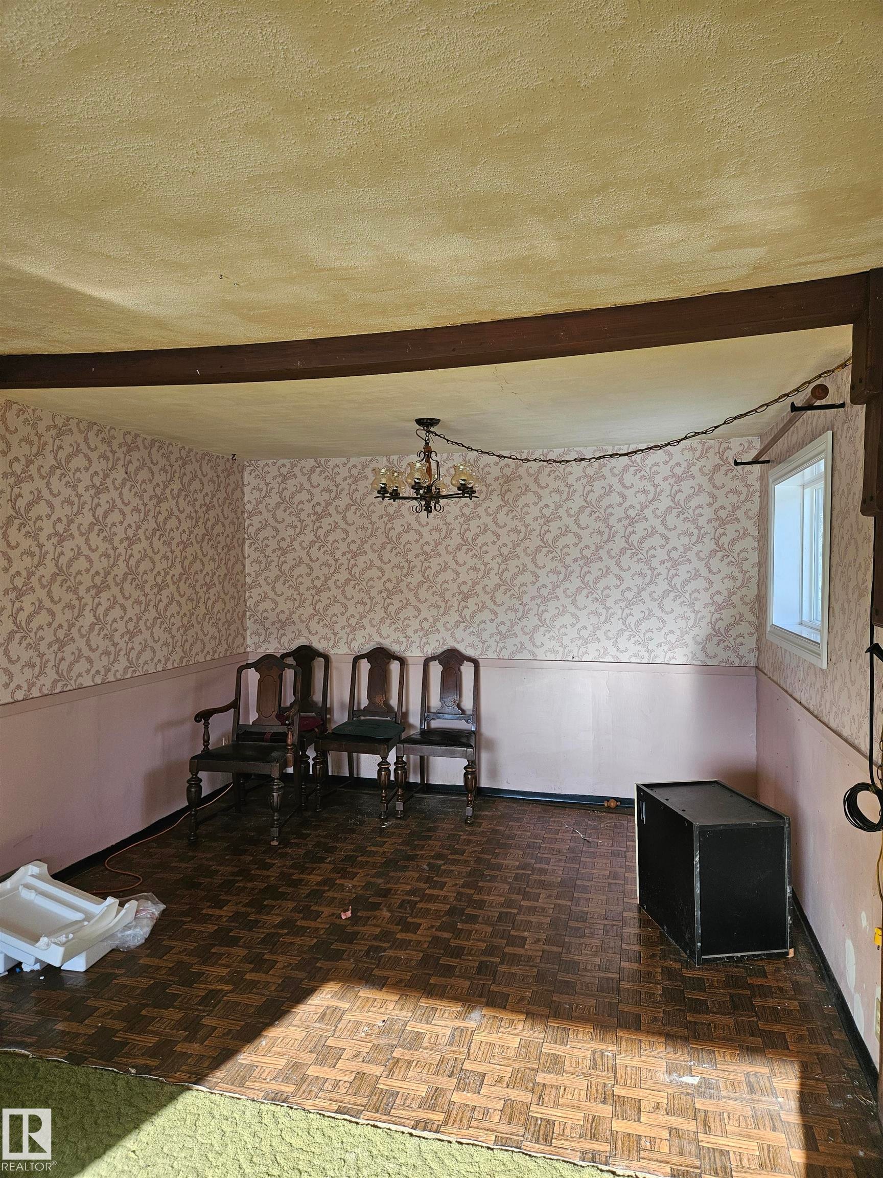 Dining space with wallpapered walls, a wainscoted wall, a textured ceiling, suspended lighting, and beam ceiling - 5314 57 Street, Cold Lake, AB - Indoor Photo Showing Other Room