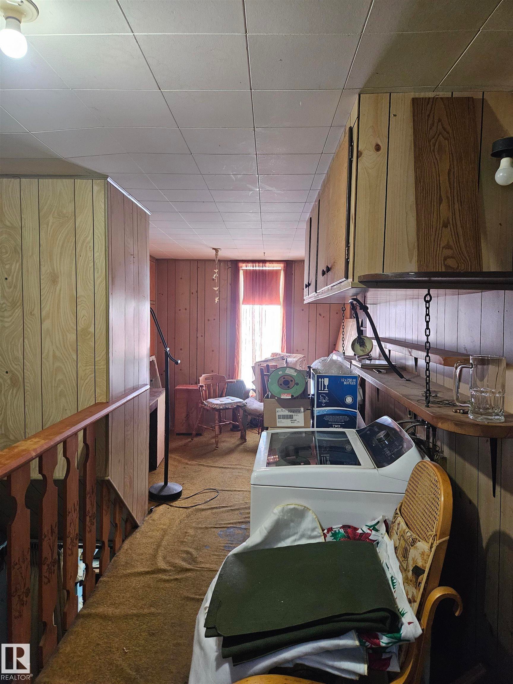 Wooden walls, washer and clothes dryer, and wood finish cabinets - 5314 57 Street, Cold Lake, AB - Indoor