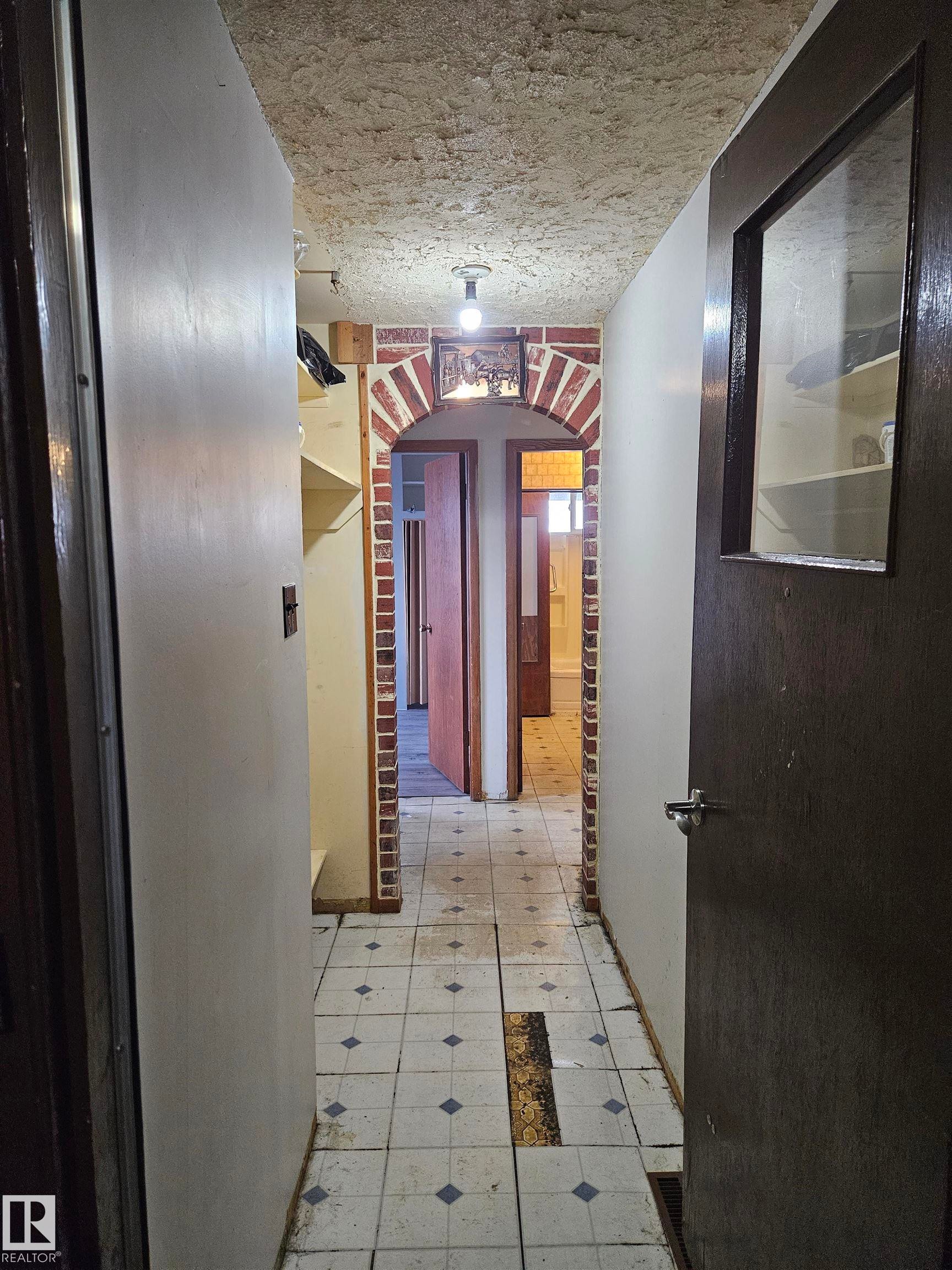 Hall featuring light flooring and arched walkways - 5314 57 Street, Cold Lake, AB - Indoor Photo Showing Other Room