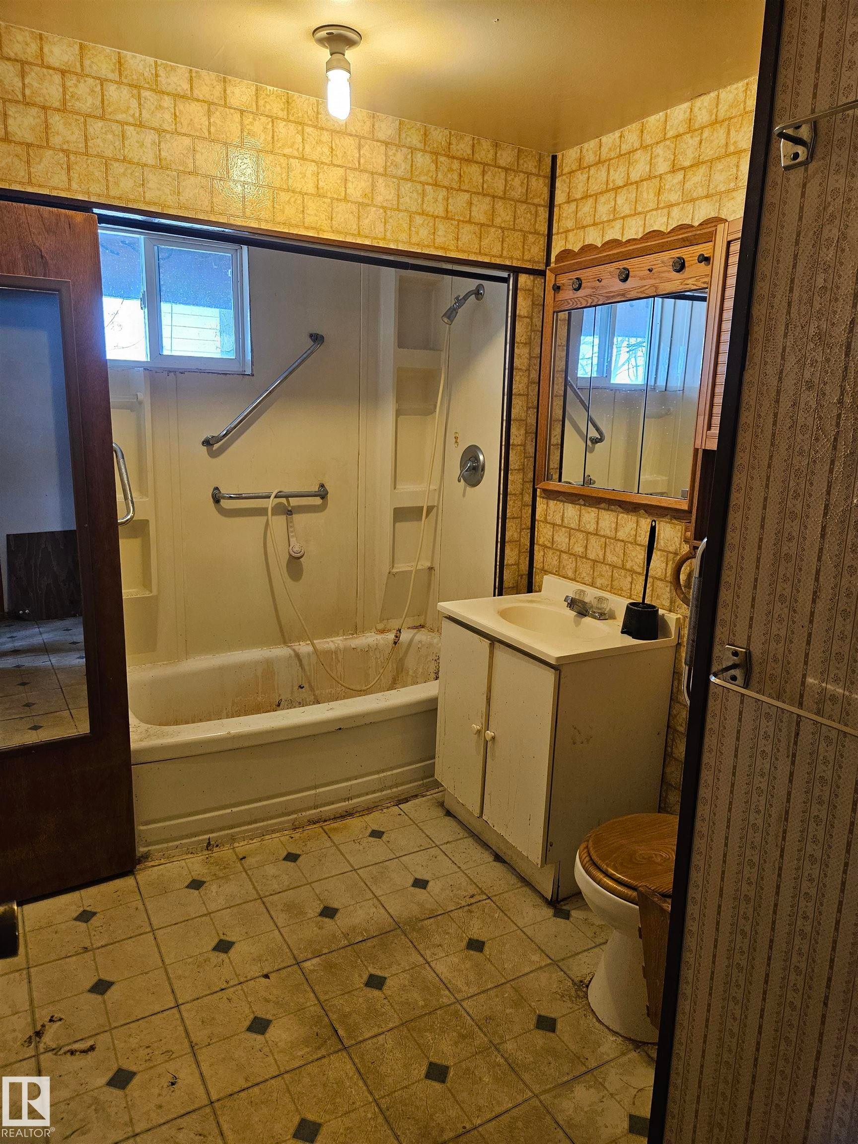 Bathroom featuring plenty of natural light, vanity, shower / tub combination, and light tile patterned floors - 5314 57 Street, Cold Lake, AB - Indoor Photo Showing Bathroom