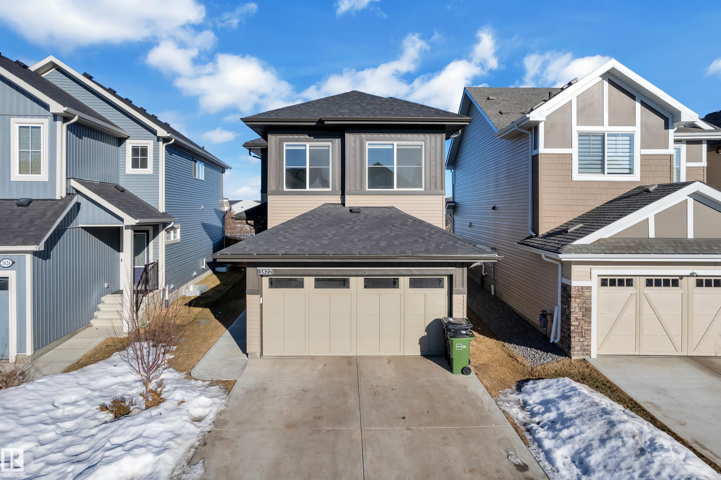 View of front facade with a shingled roof, driveway, a residential view, and an attached garage - 1822 Collip View, Edmonton, AB