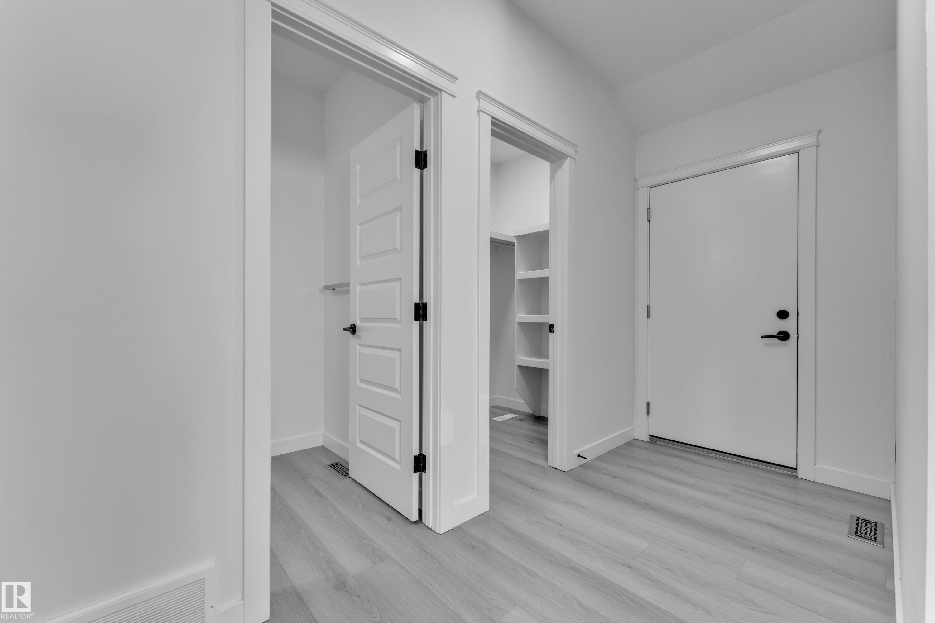 Entrance foyer featuring light wood-type flooring and vaulted ceiling - 1822 Collip View, Edmonton, AB