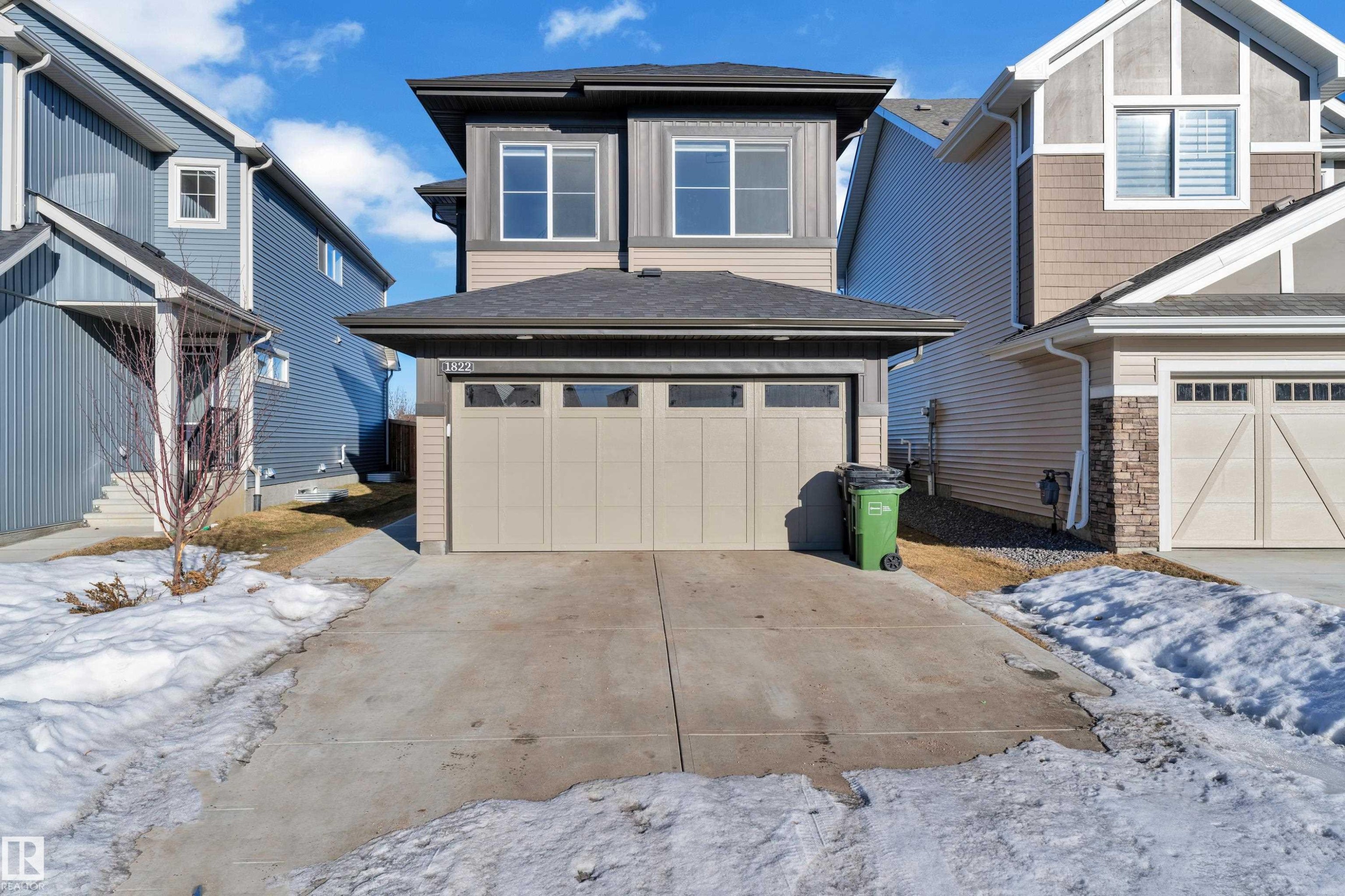 View of front facade featuring an attached garage, concrete driveway, and roof with shingles - 1822 Collip View, Edmonton, AB