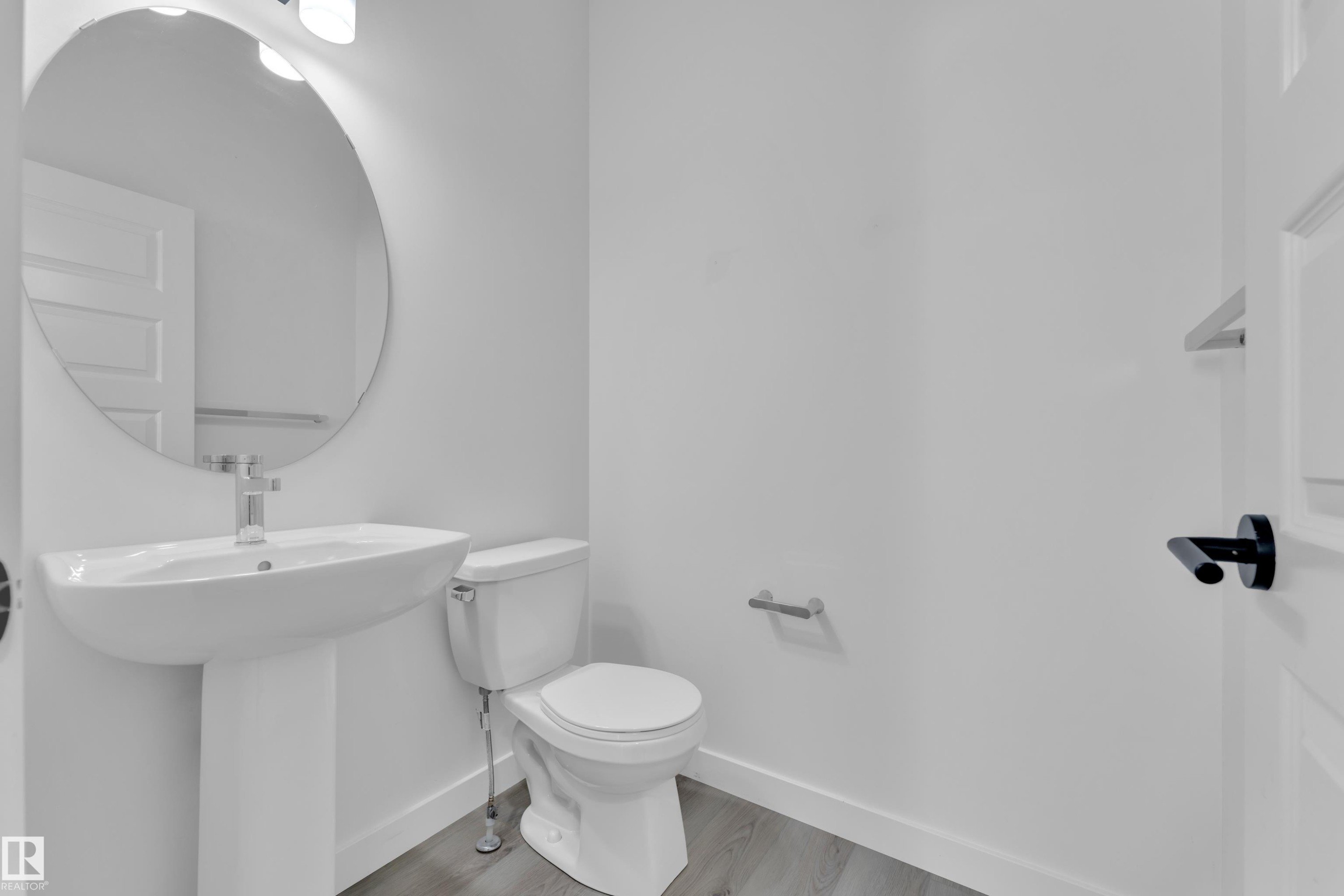 Half bath with toilet and light wood-style flooring - 1822 Collip View, Edmonton, AB