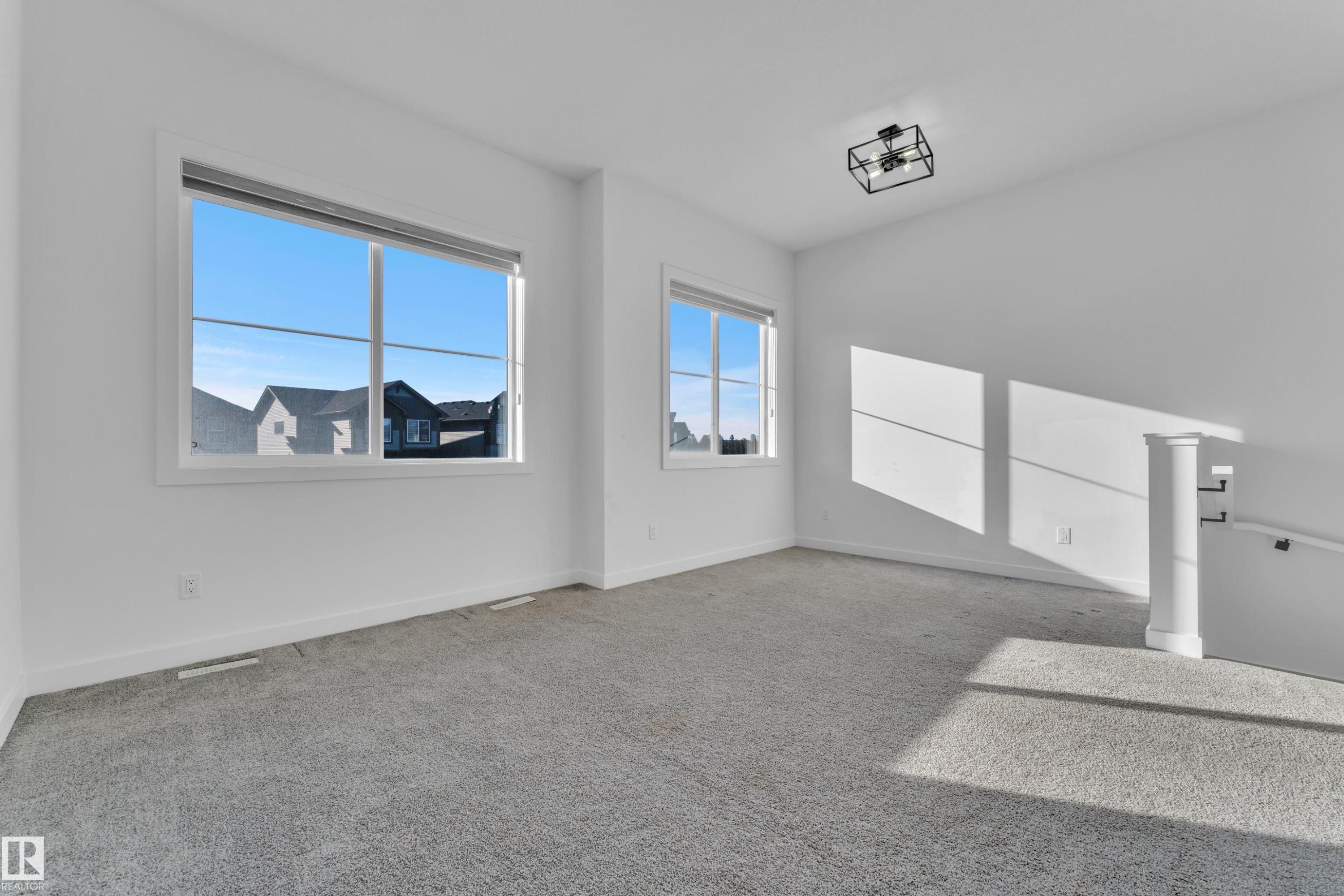 Carpeted spare room featuring baseboards - 1822 Collip View, Edmonton, AB