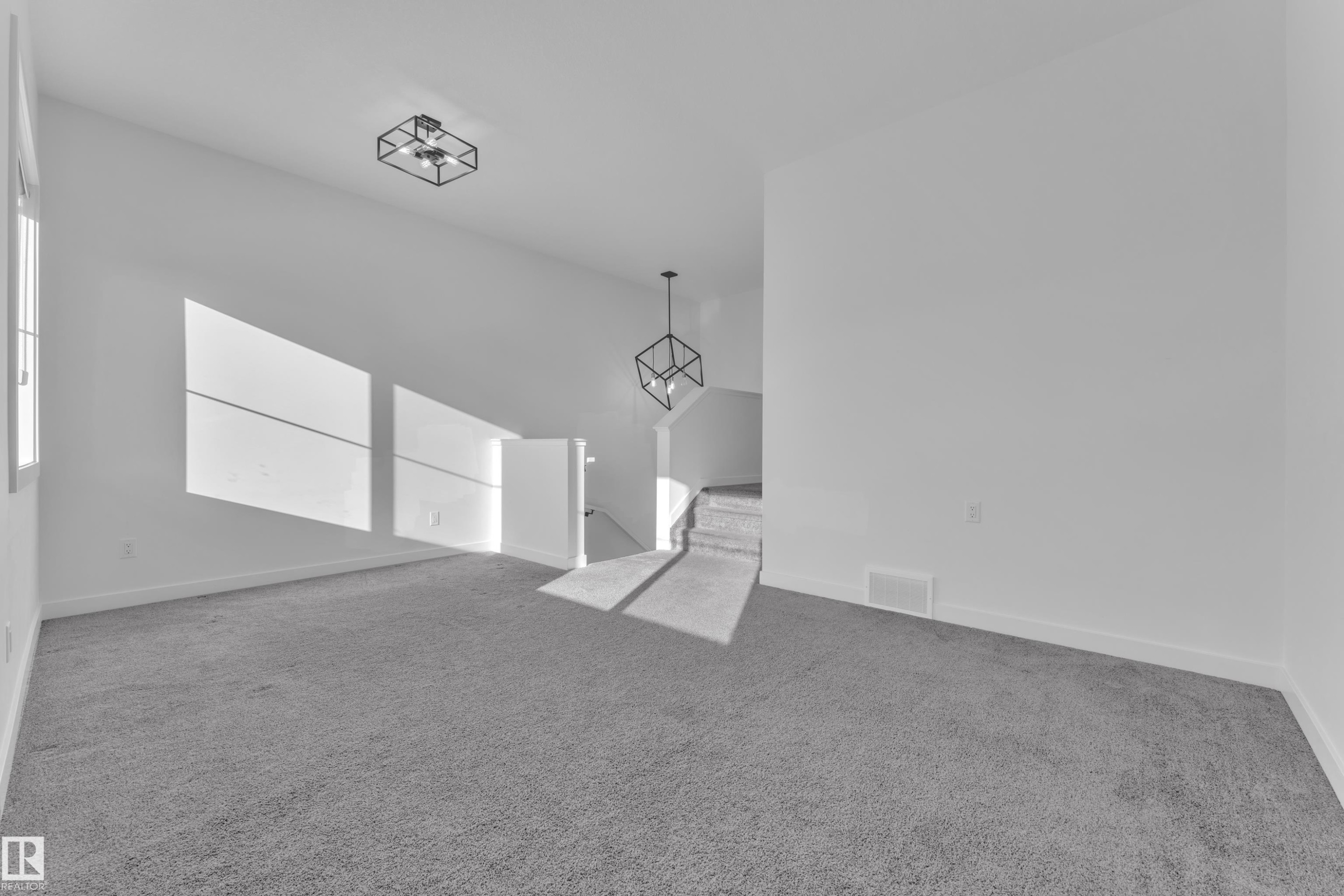 Unfurnished room with light colored carpet and baseboards - 1822 Collip View, Edmonton, AB