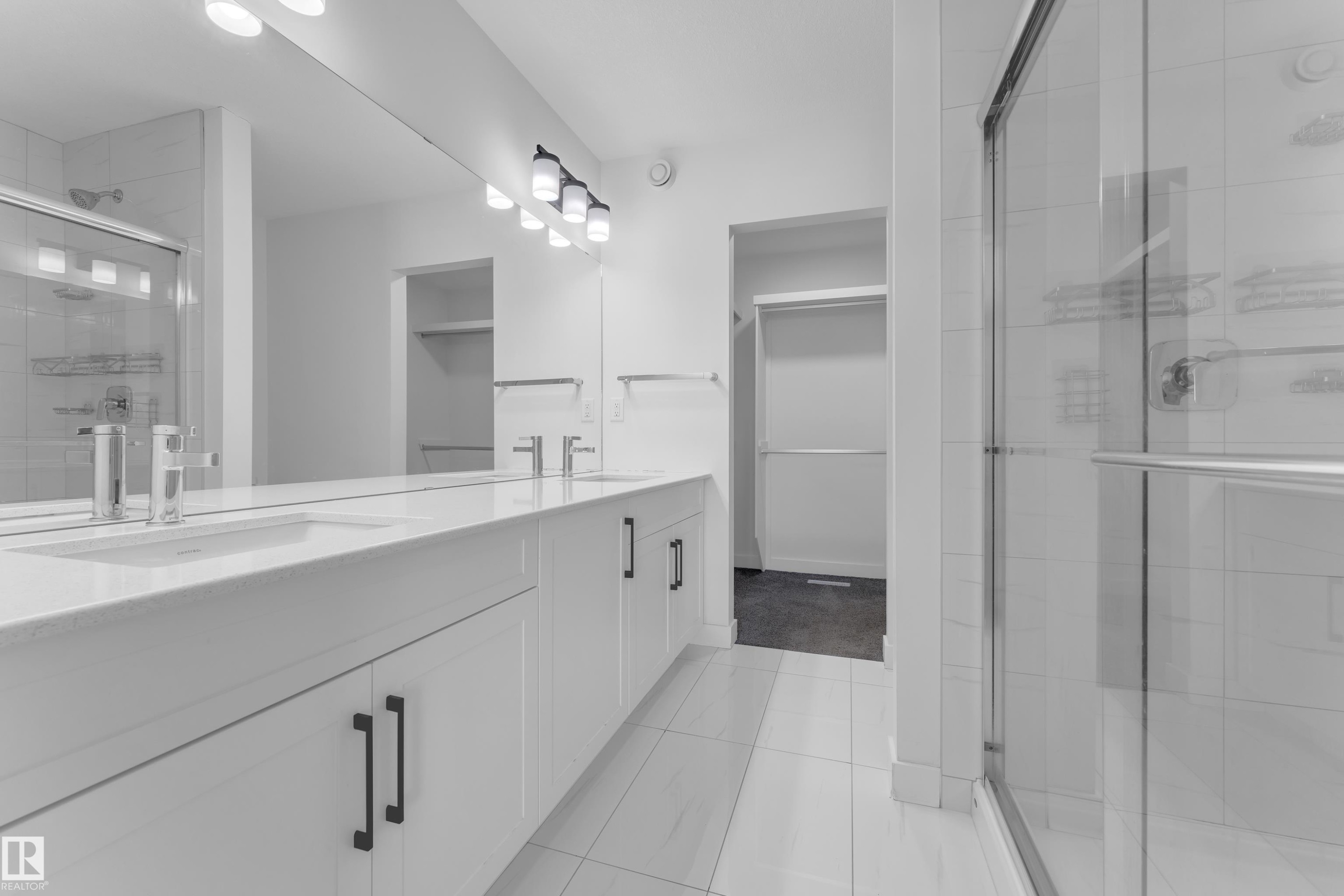 Full bathroom featuring a stall shower, double vanity, a walk in closet, and light tile patterned flooring - 1822 Collip View, Edmonton, AB
