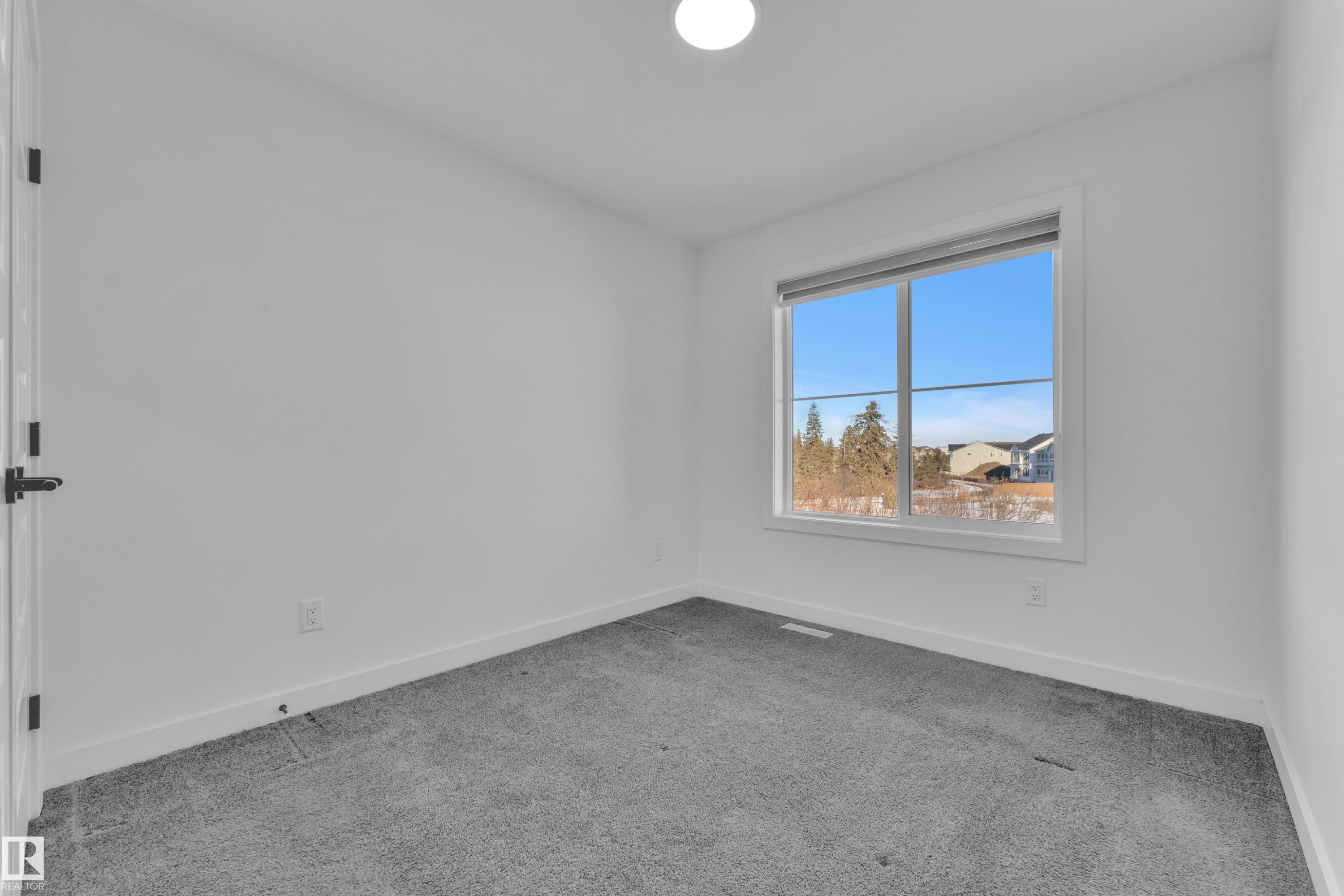 Empty room with carpet - 1822 Collip View, Edmonton, AB