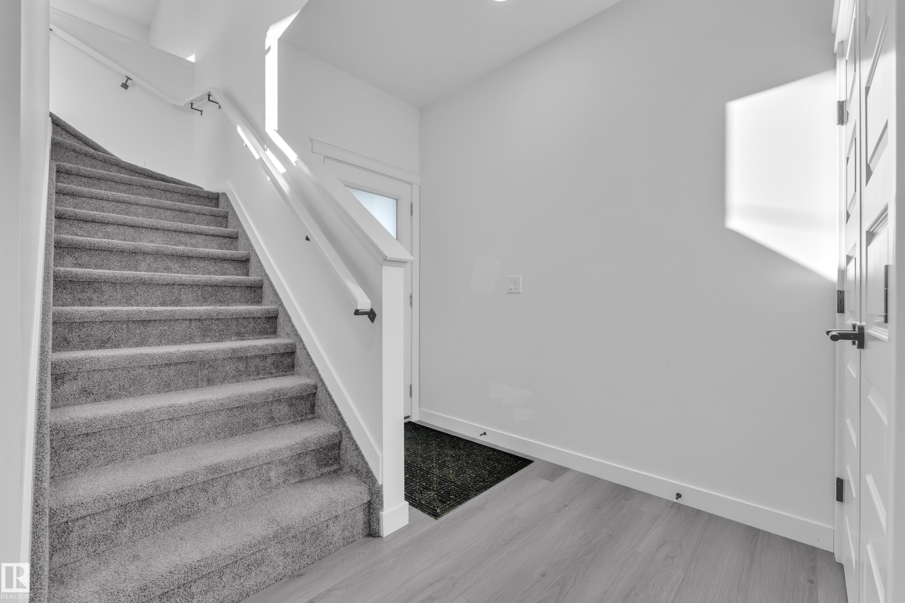 Staircase featuring baseboards and wood finished floors - 1822 Collip View, Edmonton, AB