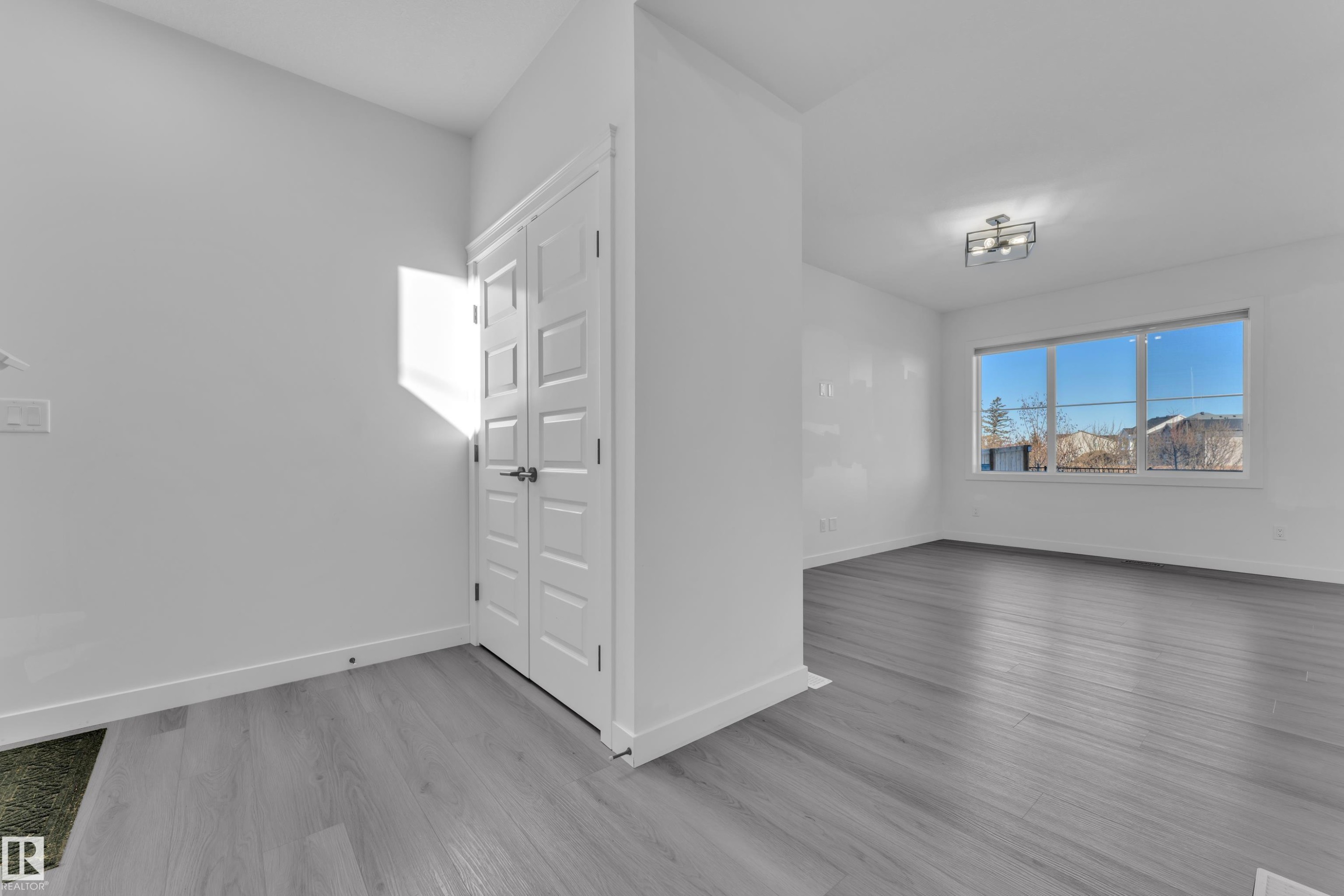 Empty room featuring baseboards and light wood-style floors - 1822 Collip View, Edmonton, AB