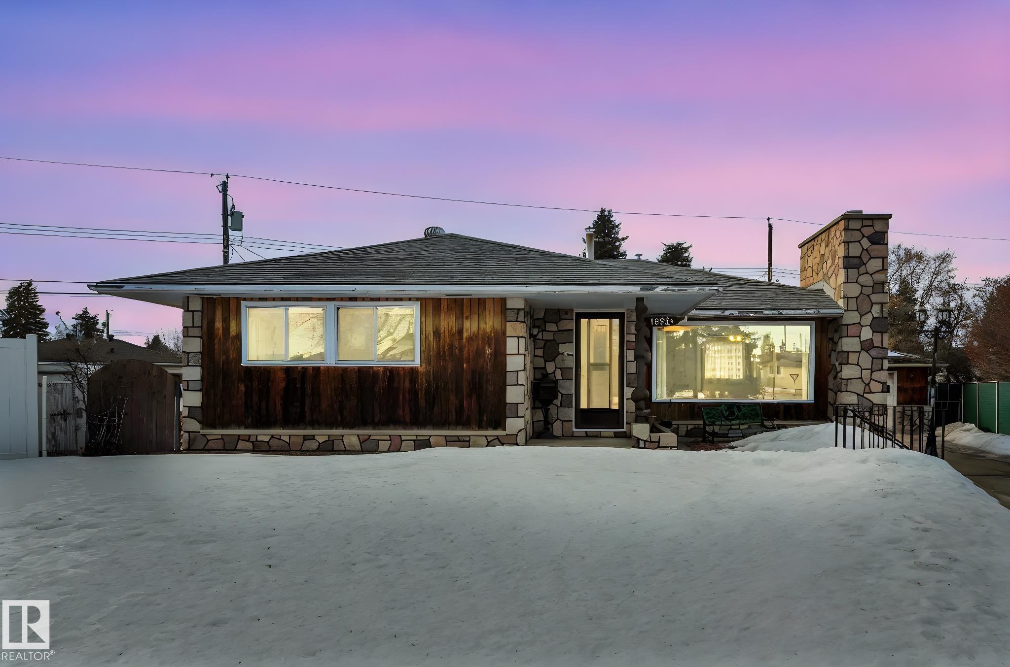 View of front of property featuring roof with shingles, a chimney, and stone siding - 10324 42 Street, Edmonton, AB - Outdoor