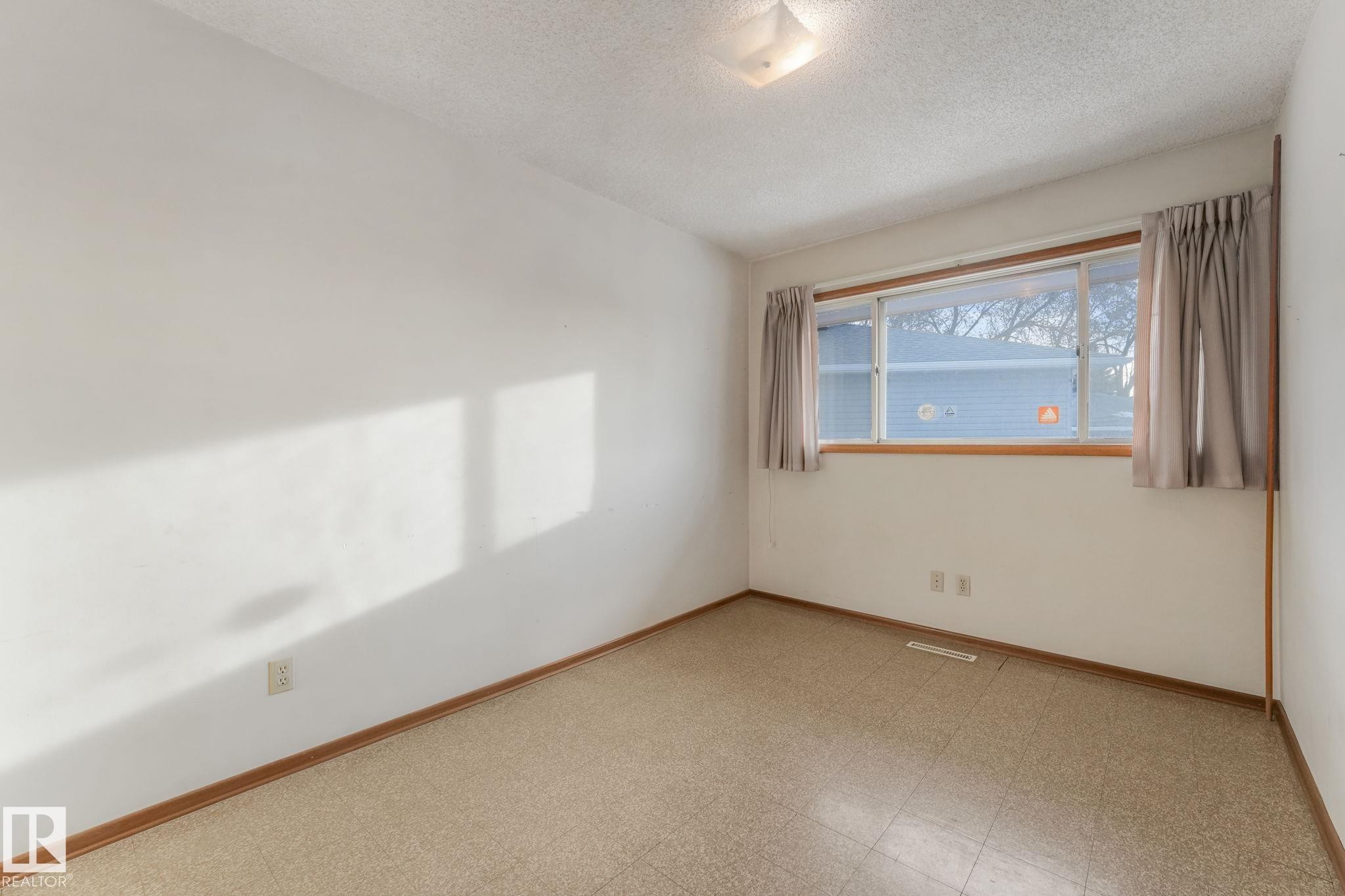 Unfurnished room with light floors and a textured ceiling - 10324 42 Street, Edmonton, AB - Indoor Photo Showing Other Room