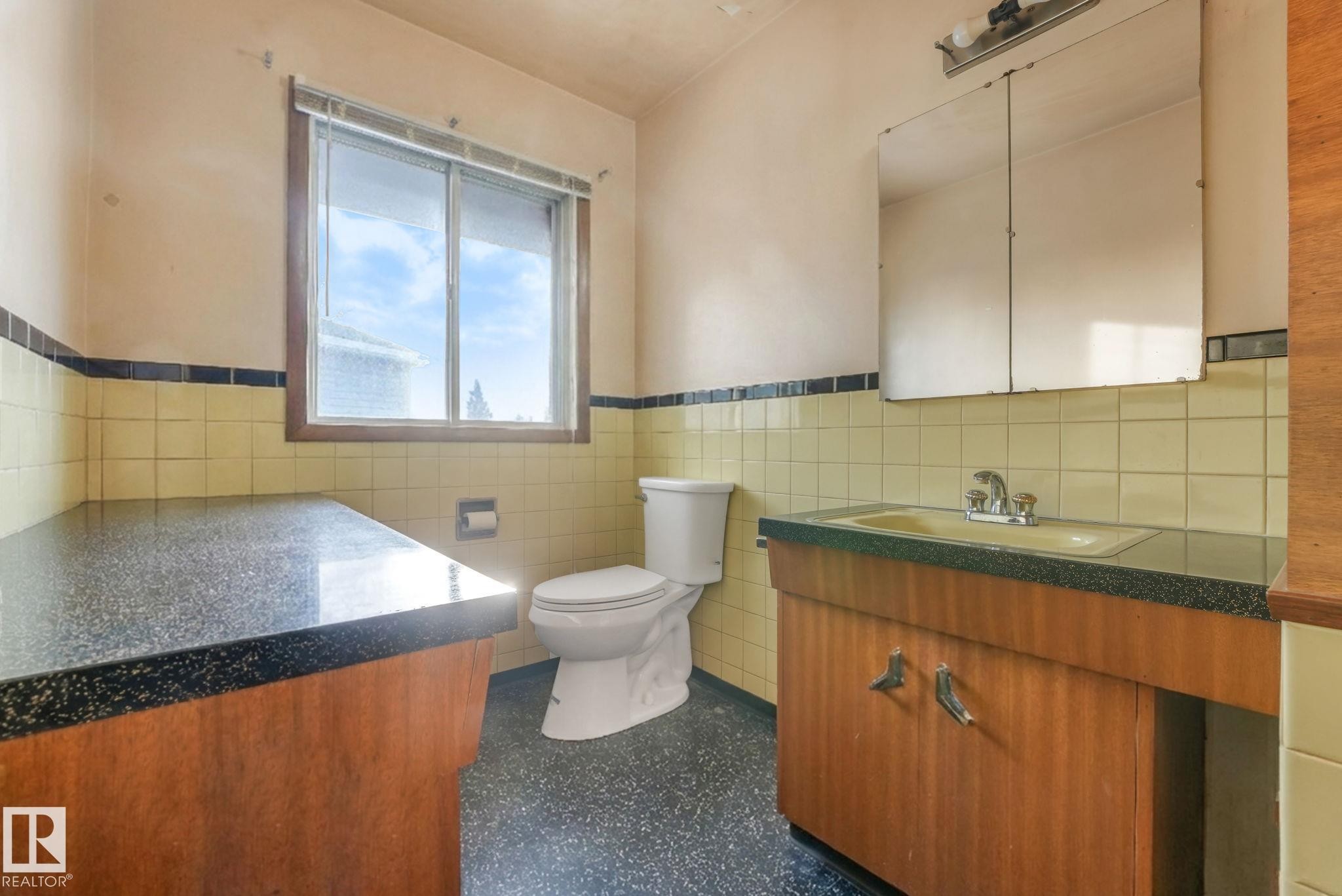 Bathroom featuring vanity, tile walls, and wainscoting - 10324 42 Street, Edmonton, AB - Indoor Photo Showing Bathroom