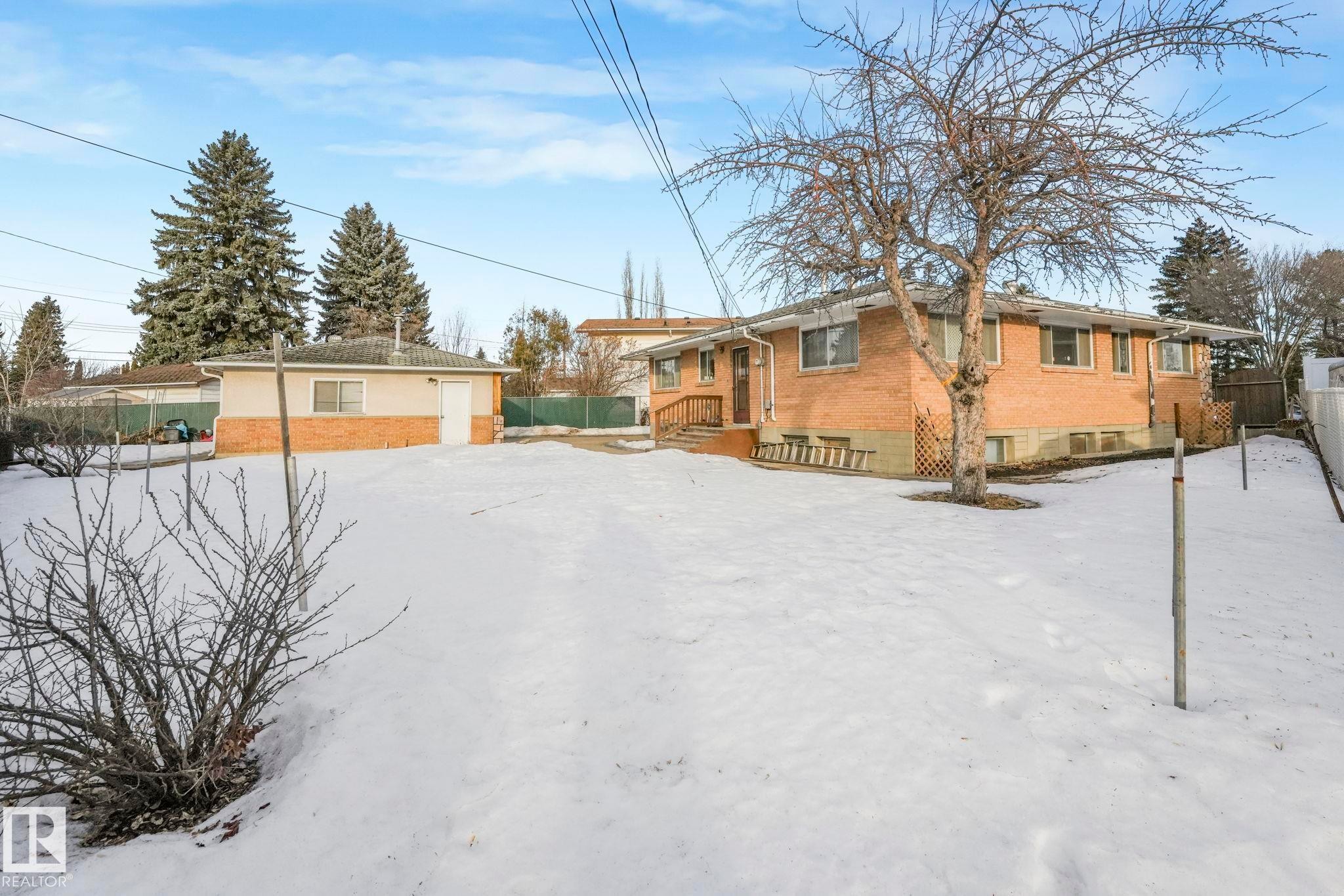 Snow covered property featuring brick siding - 10324 42 Street, Edmonton, AB - Outdoor