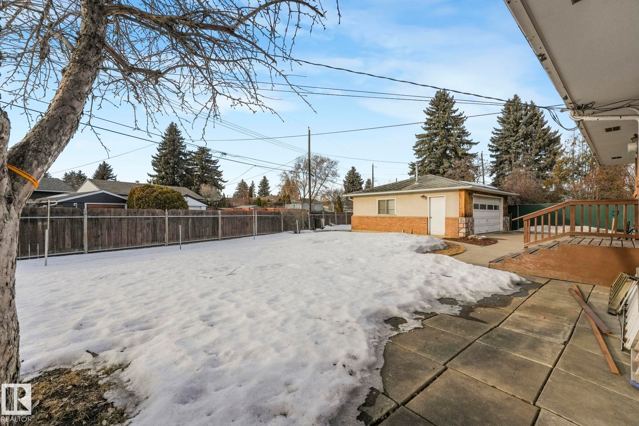 View of yard featuring an outdoor structure, a detached garage, and a patio - 10324 42 Street, Edmonton, AB - Outdoor