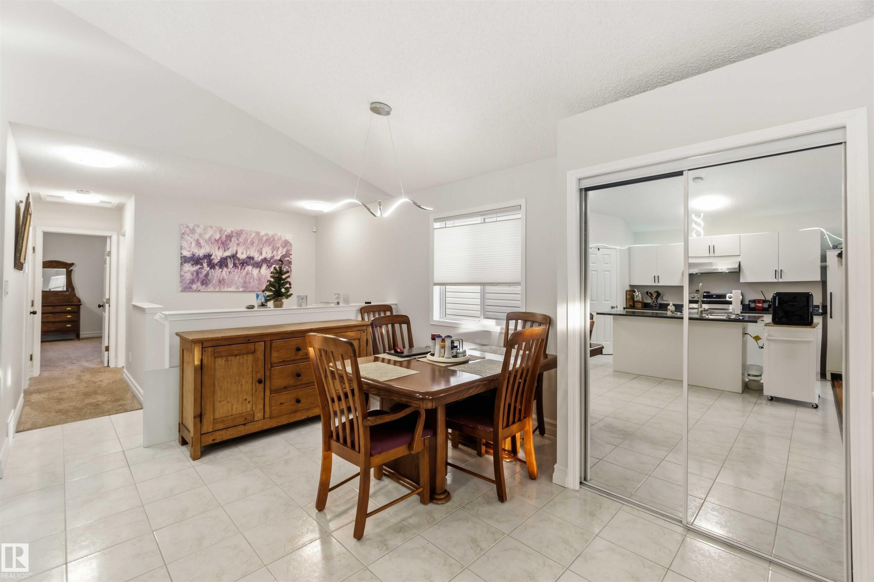 Dining room with vaulted ceiling and light tile patterned flooring - 1706 Turvey Bend, Edmonton, AB - Indoor Photo Showing Dining Room