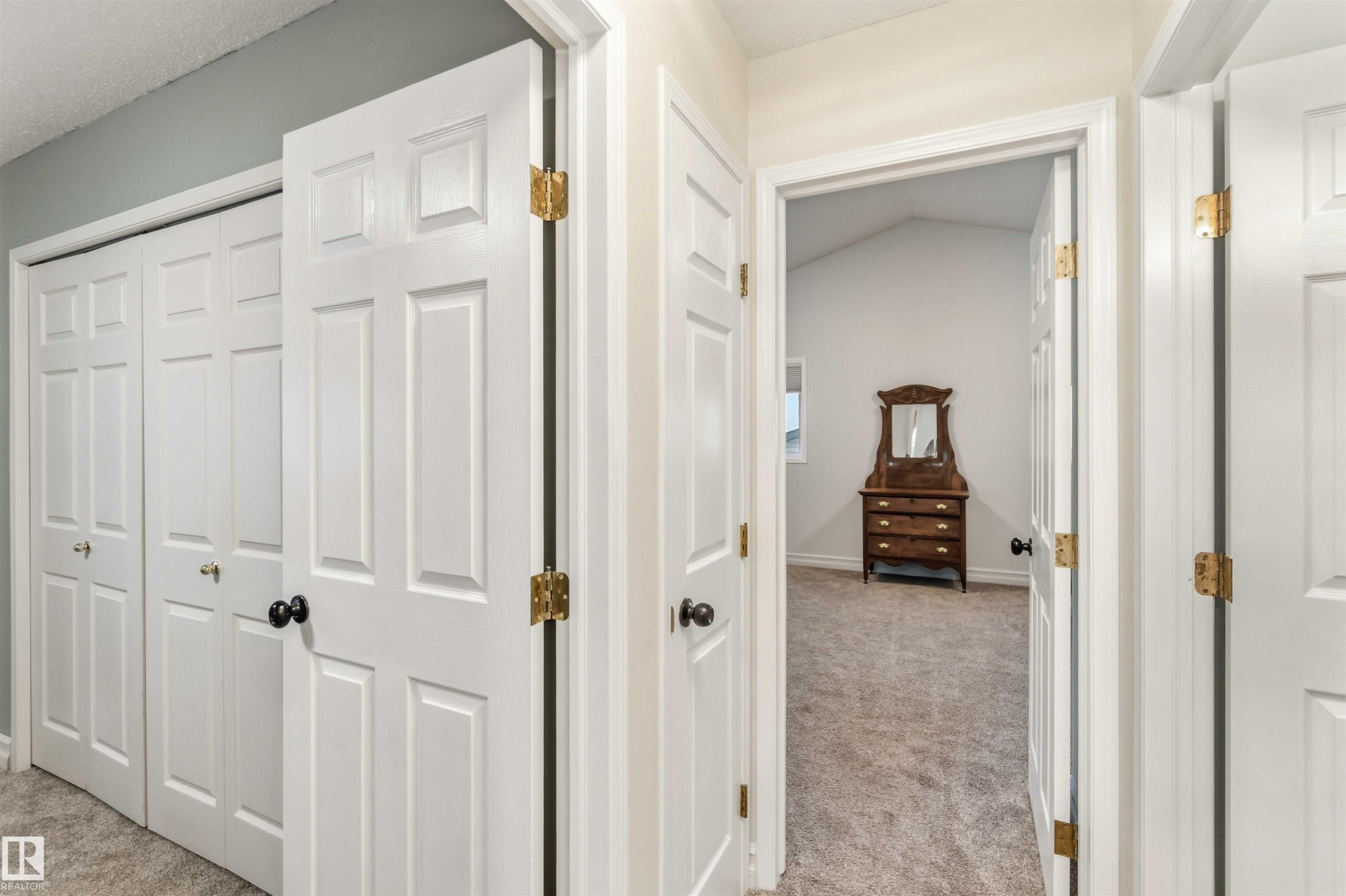 Hall with light colored carpet and baseboards - 1706 Turvey Bend, Edmonton, AB - Indoor Photo Showing Other Room