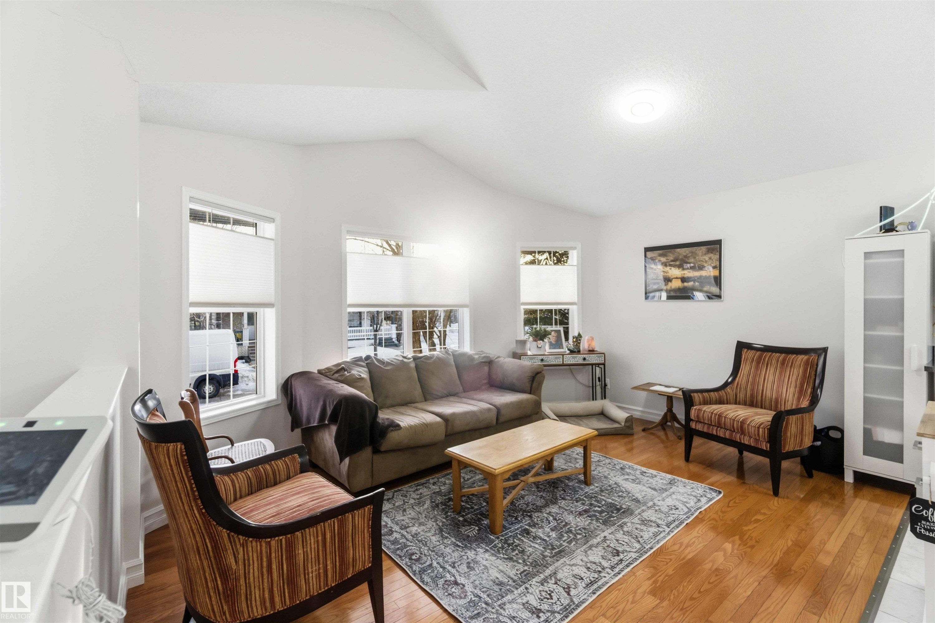 Living area featuring light wood-style flooring and lofted ceiling - 1706 Turvey Bend, Edmonton, AB - Indoor Photo Showing Living Room