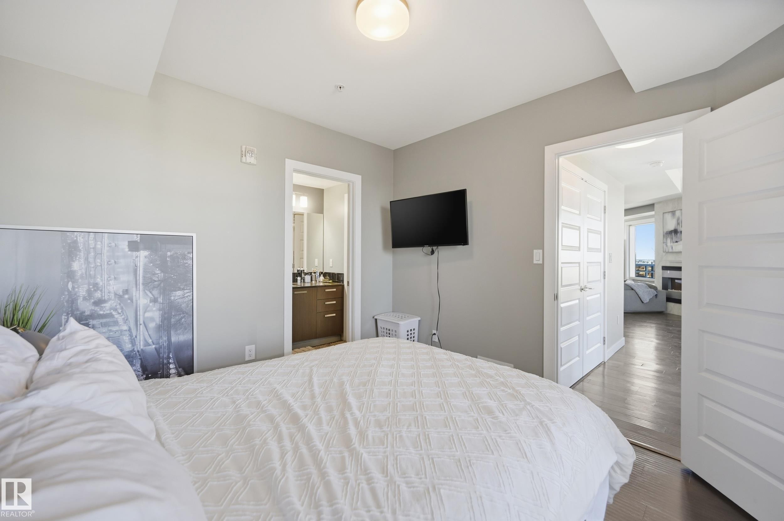 Bedroom with wood finished floors and ensuite bathroom - 2003 10388 105 Street, Edmonton, AB - Indoor Photo Showing Bedroom