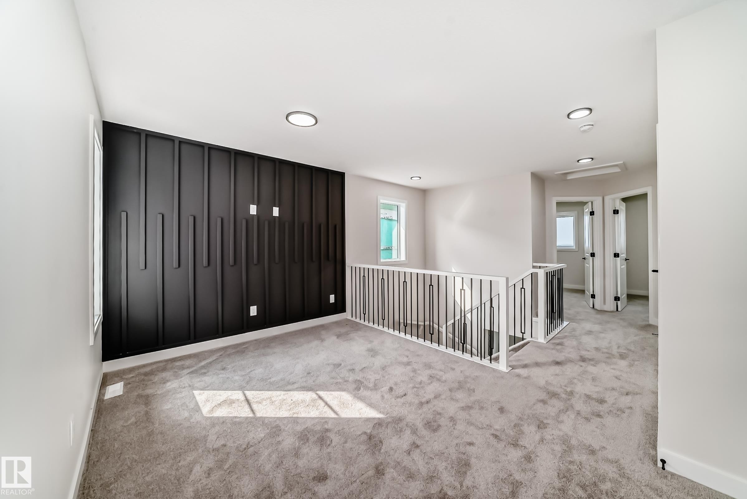 Empty room featuring baseboards and light colored carpet - 135 Pierwyck Loop, Spruce Grove, AB - Indoor Photo Showing Other Room