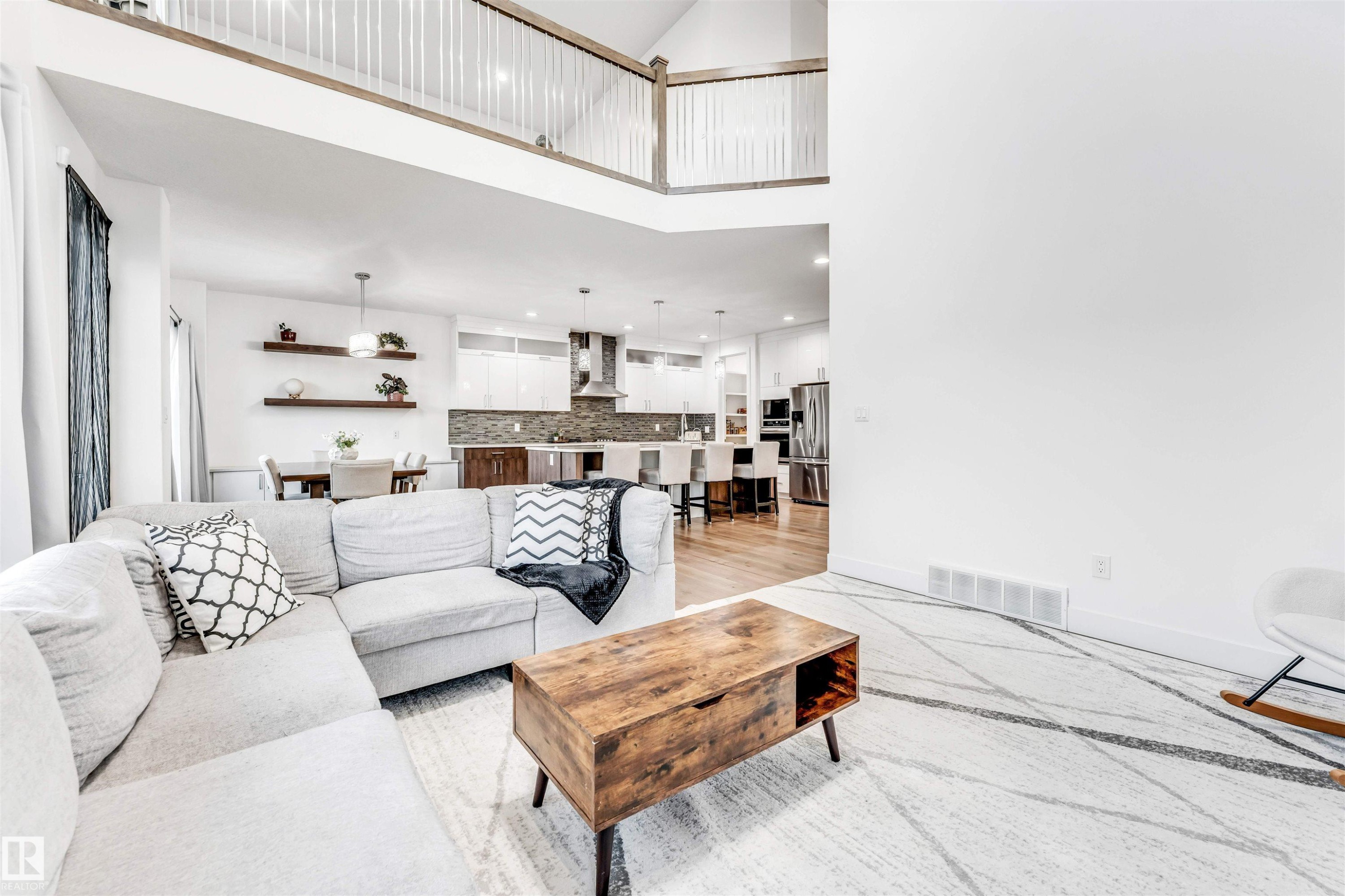 Living area featuring a high ceiling, light wood-type flooring, and recessed lighting - 1407 Graydon Hill Way, Edmonton, AB - Indoor Photo Showing Living Room