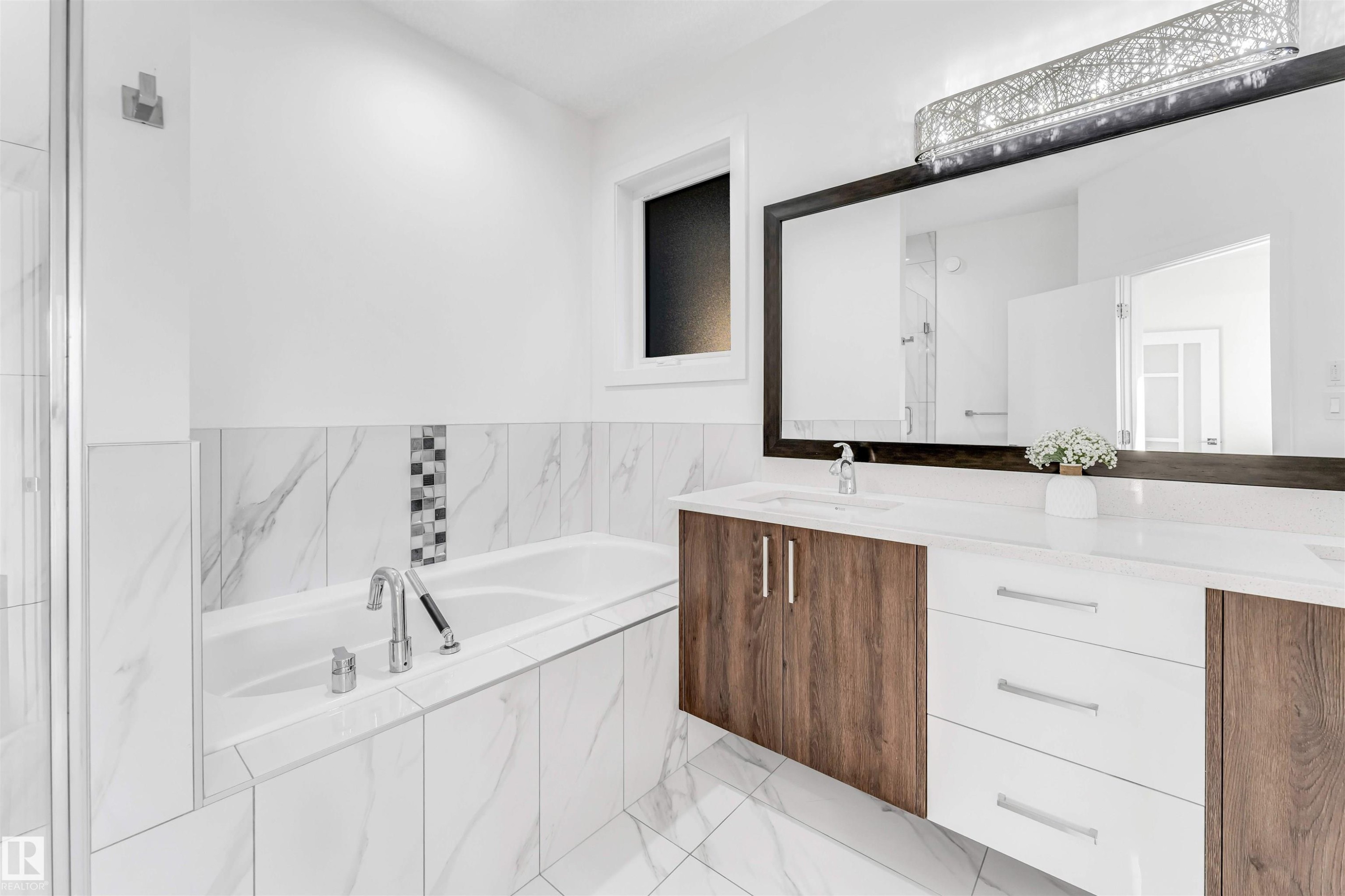 Bathroom with a bath, double vanity, and light marble finish flooring - 1407 Graydon Hill Way, Edmonton, AB - Indoor Photo Showing Bathroom
