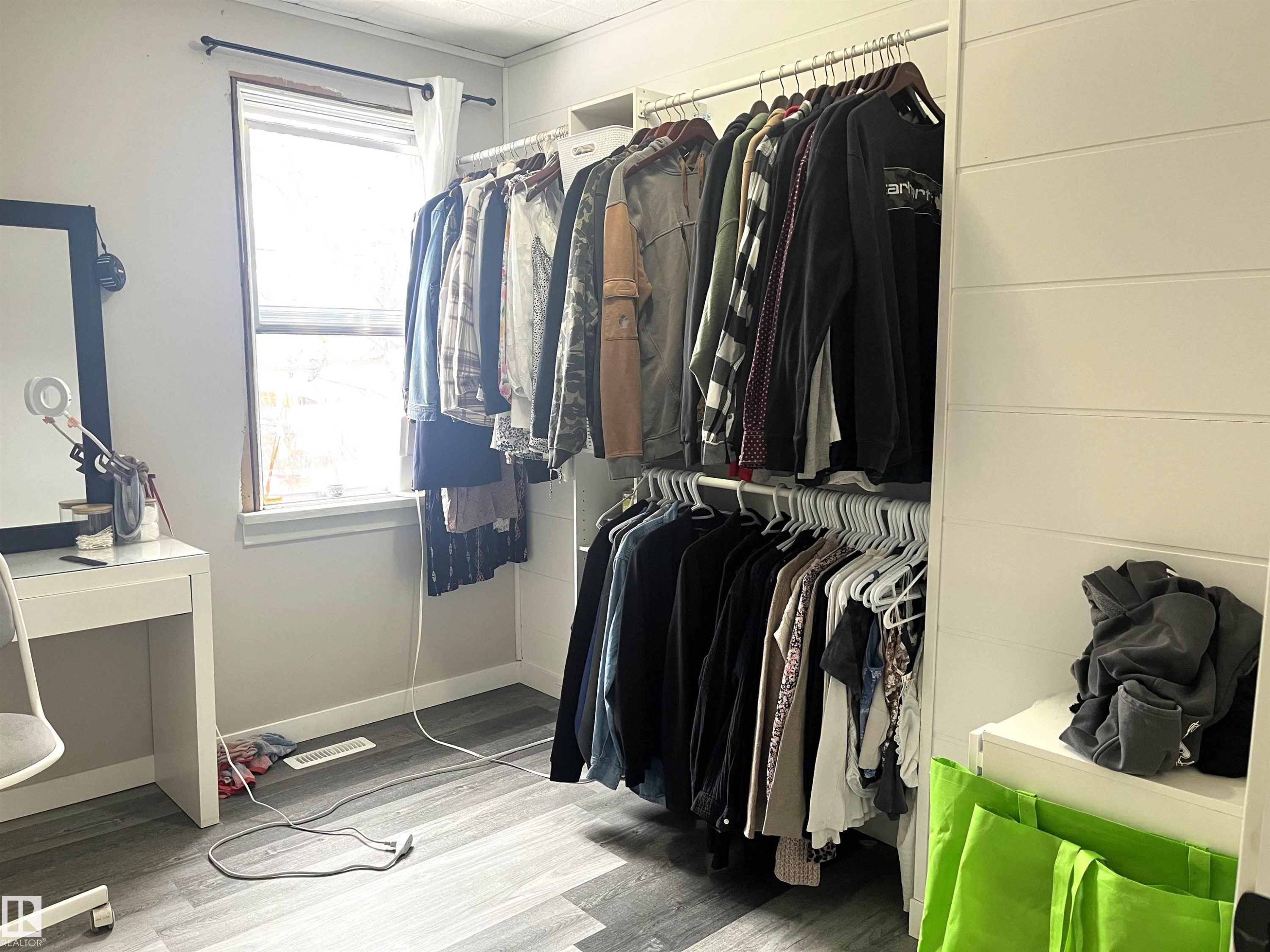 Walk in closet with wood finished floors - 4811 48 Ave, Evansburg, AB - Indoor With Storage