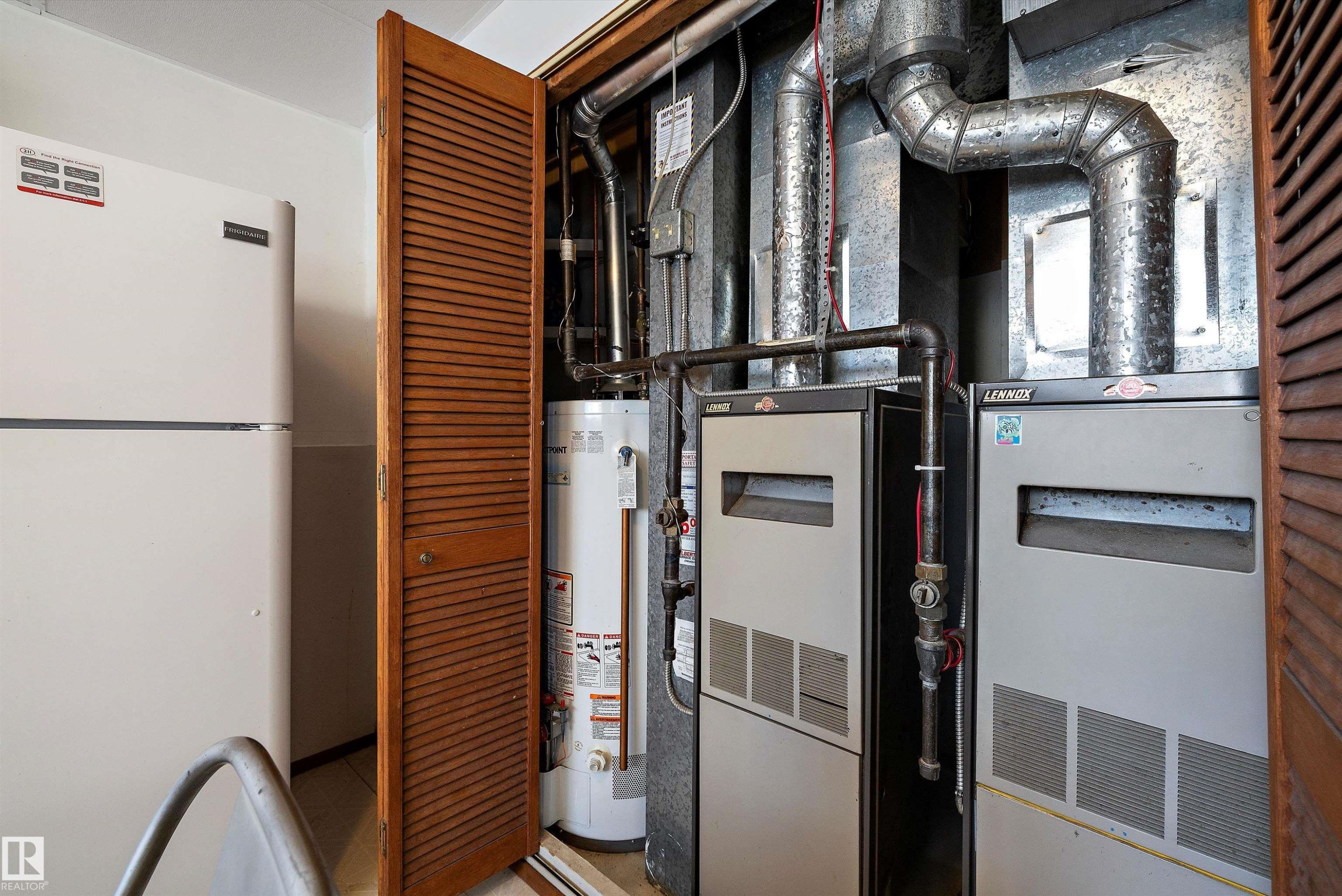 Utilities featuring gas water heater and heating unit - 12117 91 Street, Edmonton, AB - Indoor Photo Showing Basement